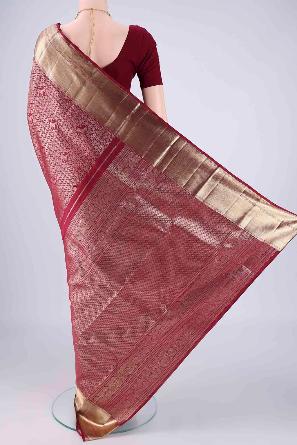 Flat view of Maroon Kanchipuram Silk Saree with Zari Brocade on the body and Zari Border. 
