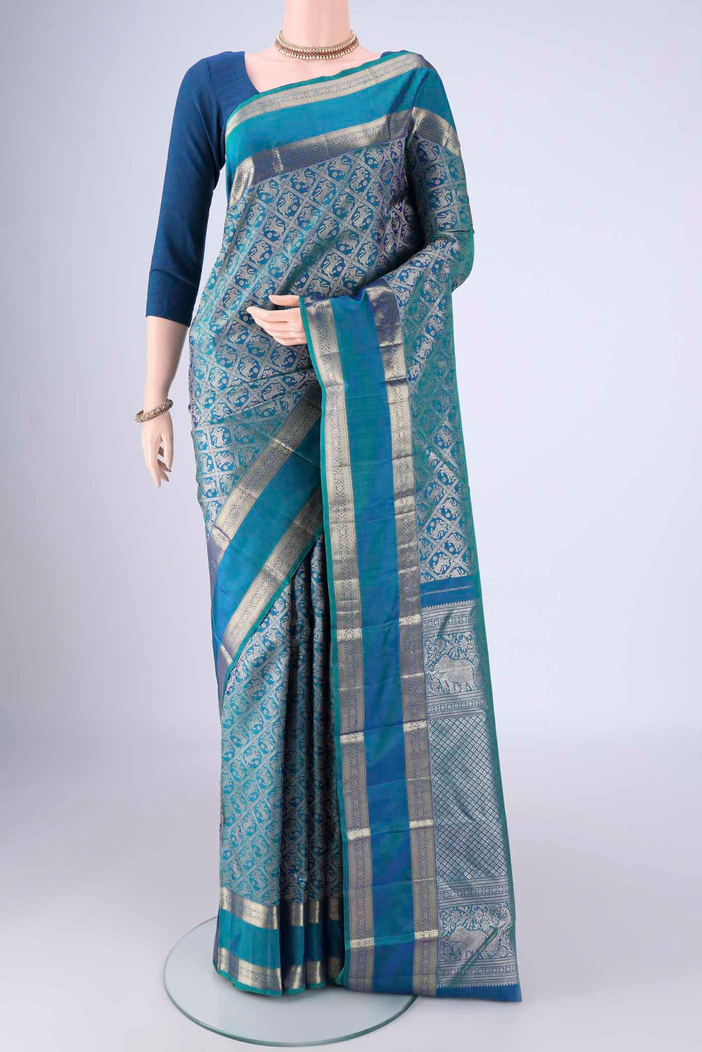 Peacock Blue Kanchipuram Silk Saree with Zari Brocade on the body and Zari Border.  displayed on a mannequin