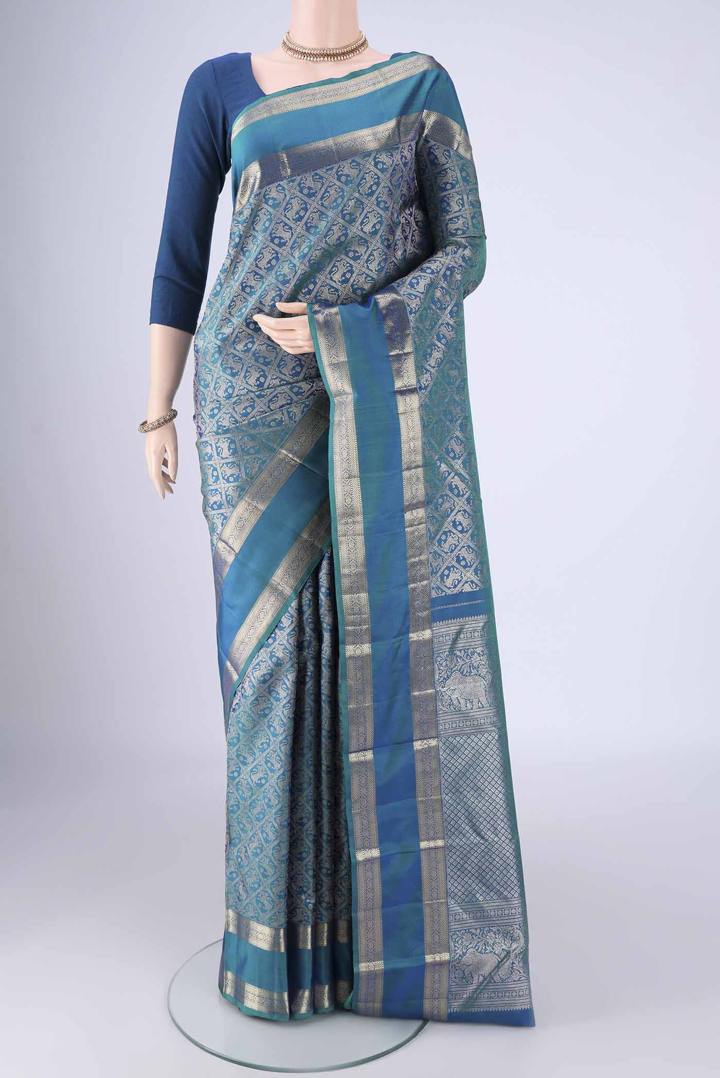 Peacock Blue Kanchipuram Silk Saree with Zari Brocade on the body and Zari Border.  displayed on a mannequin