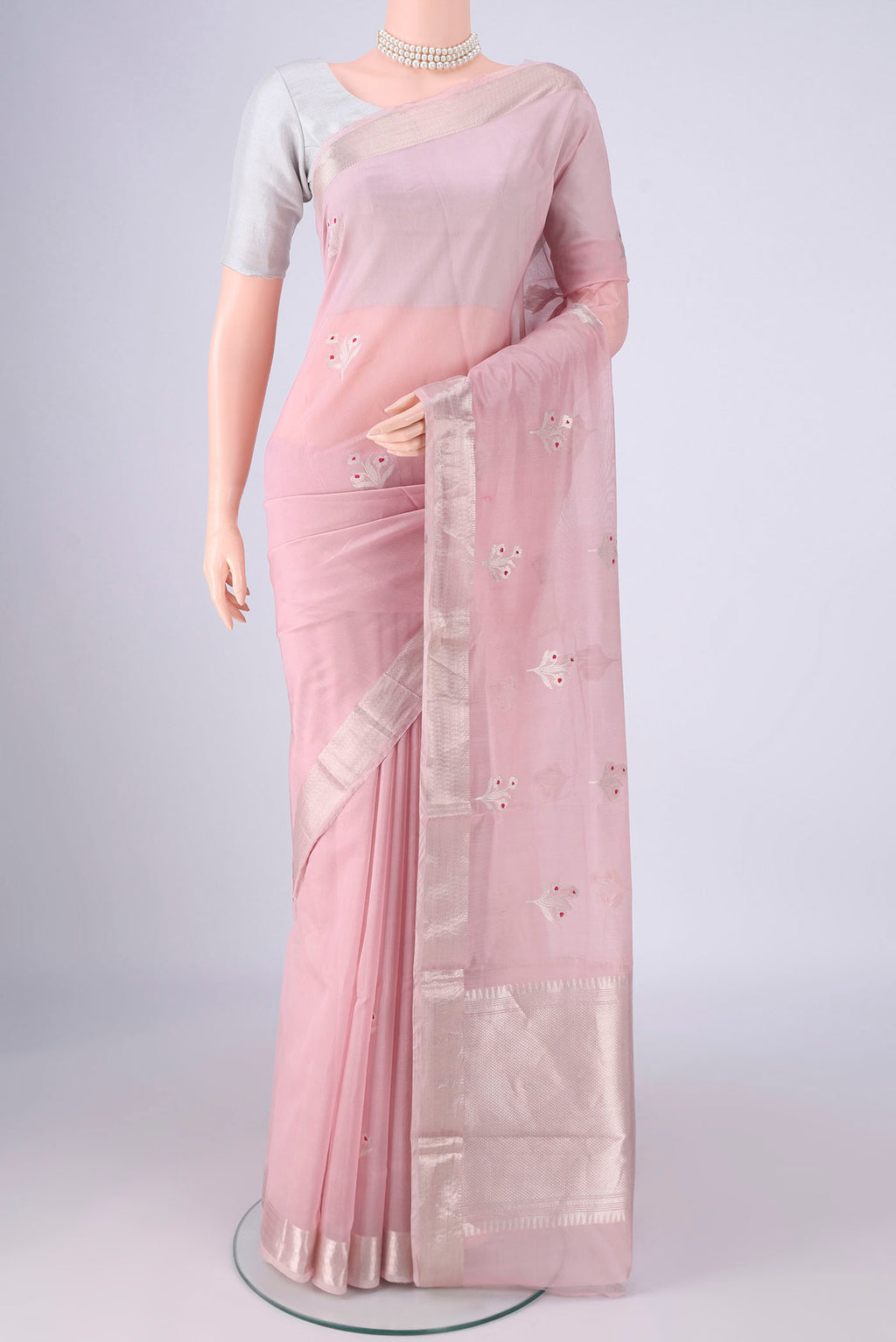 Rose pink Banarasi Kora Cotton Saree with Zari Butta on the body and Zari Border.  displayed on a mannequin