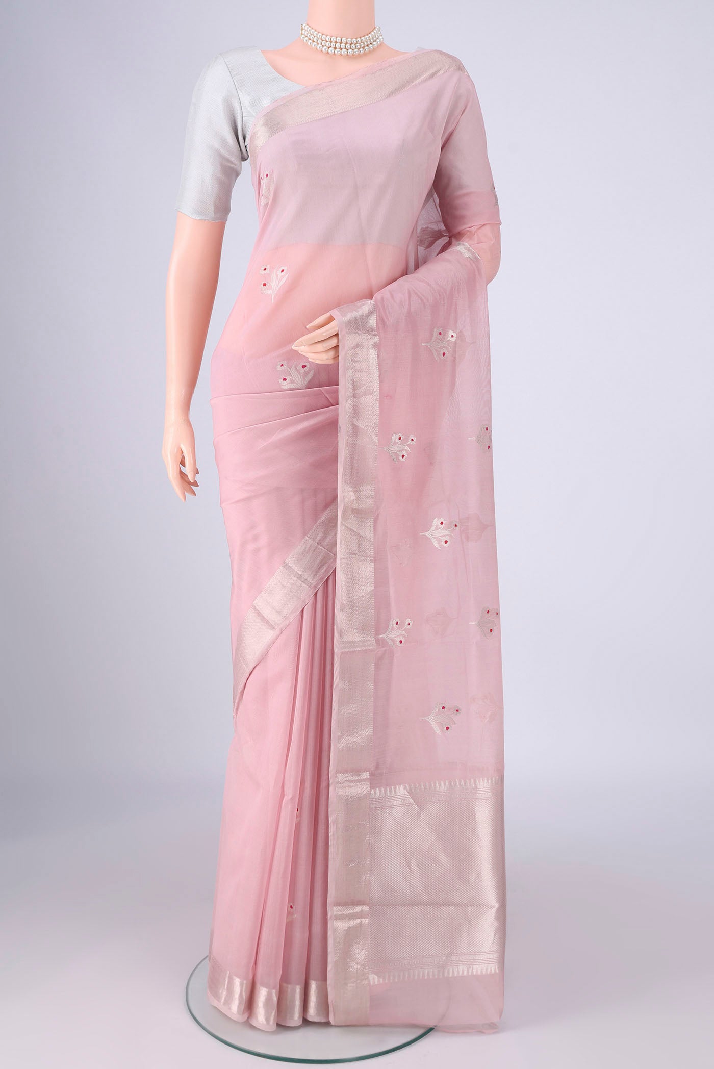 Rose pink Banarasi Kora Cotton Saree with Zari Butta on the body and Zari Border.  displayed on a mannequin