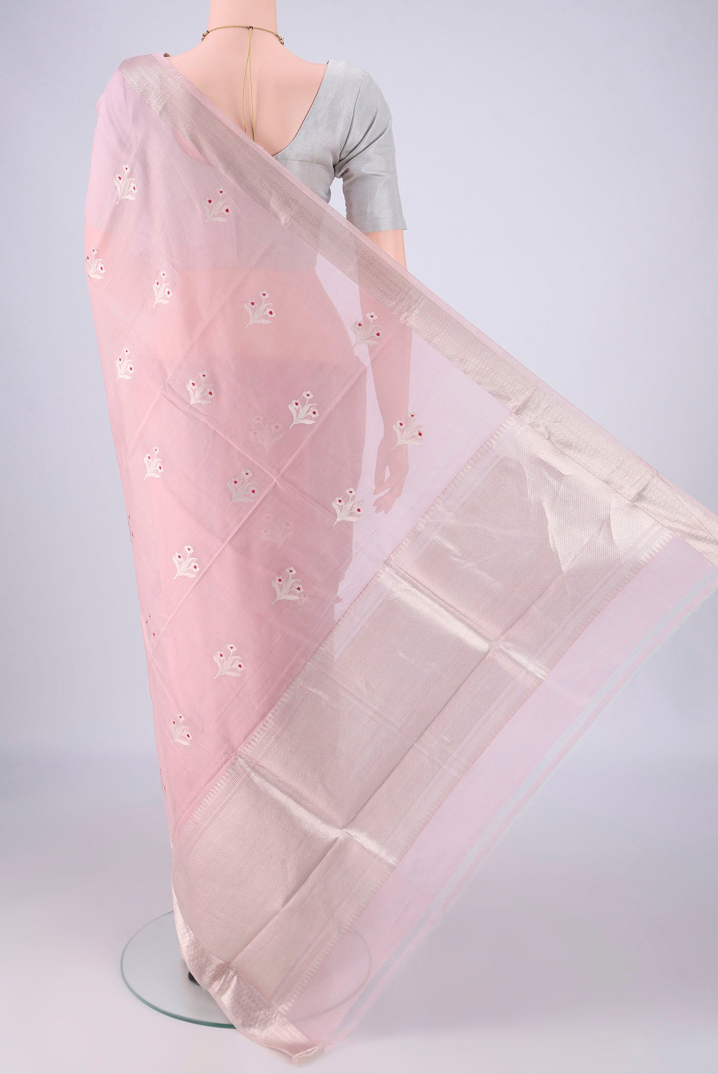 Flat view of Rose pink Banarasi Kora Cotton Saree with Zari Butta on the body and Zari Border. 