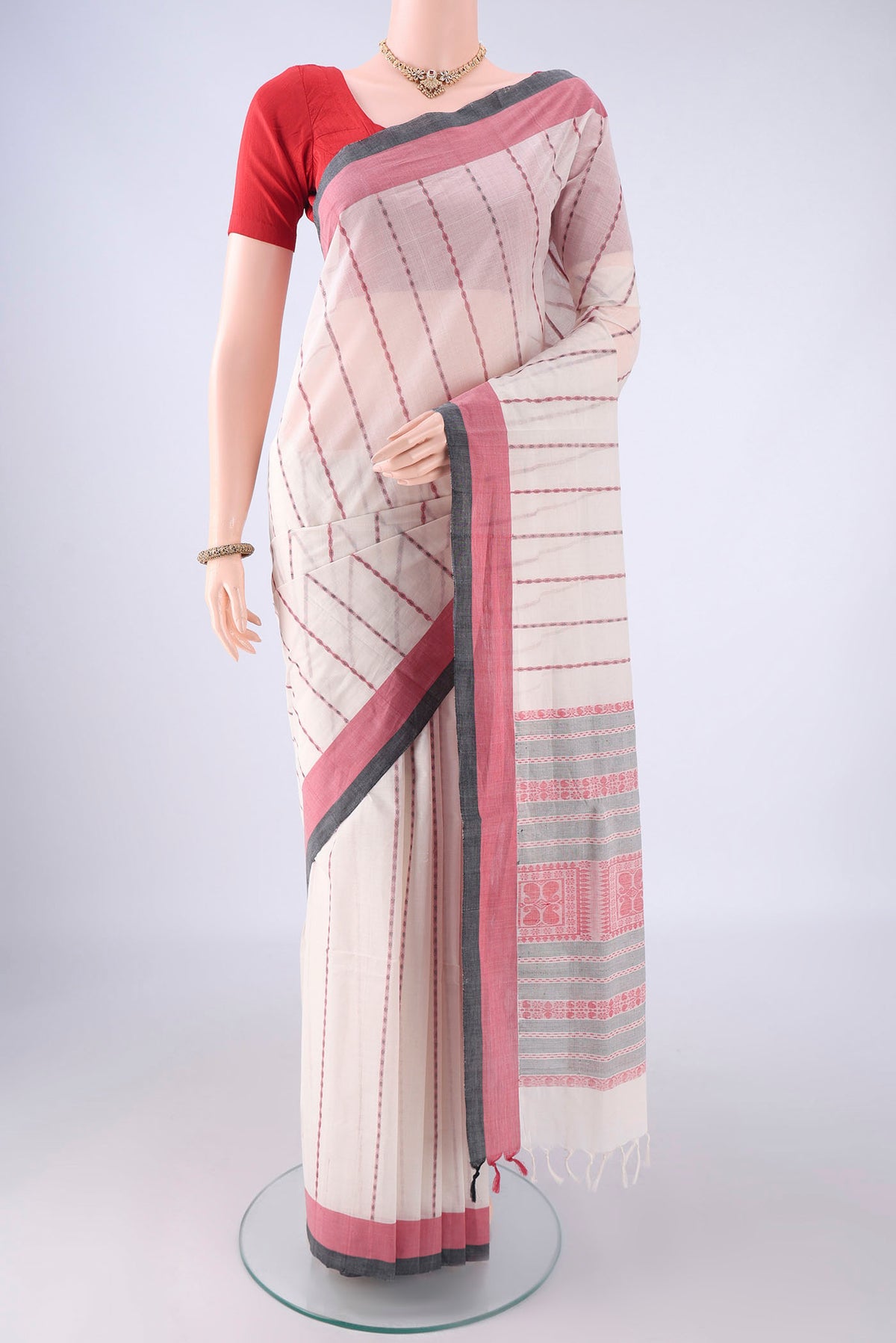 White Coimbatore Cotton Saree with Stripes on the body and Thread Border.  displayed on a mannequin