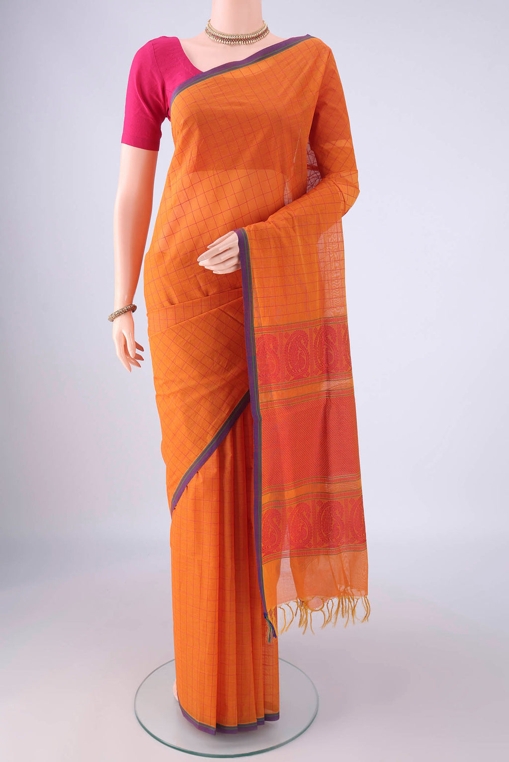 Orange Coimbatore Cotton Saree with Checked design on the body and Thread Border.  displayed on a mannequin