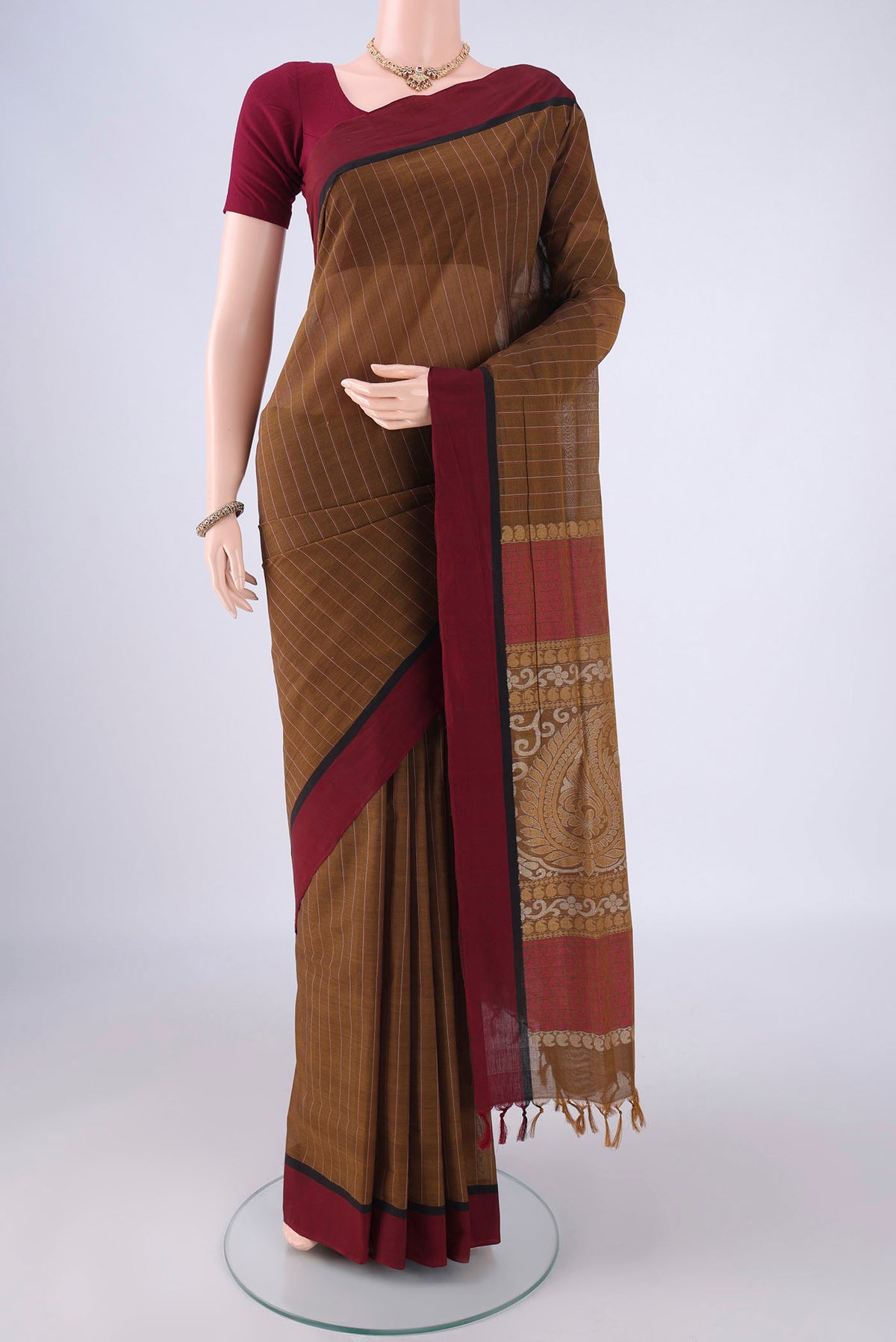 Brown Coimbatore Cotton Saree with Stripes on the body and Thread Border.  displayed on a mannequin