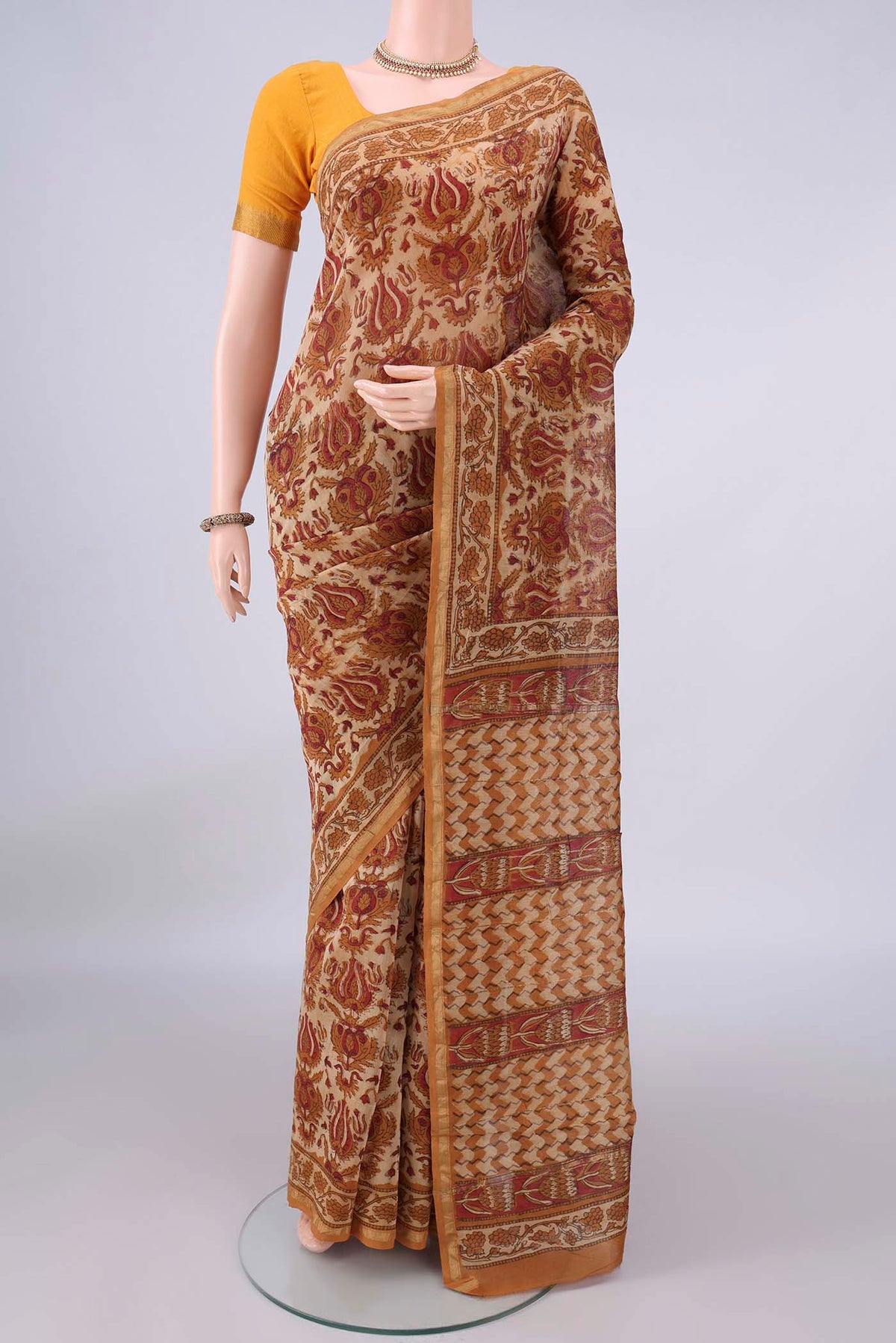 Sandal Chanderi Cotton Saree with Batik Print on the body and Thin Zari Line.  displayed on a mannequin