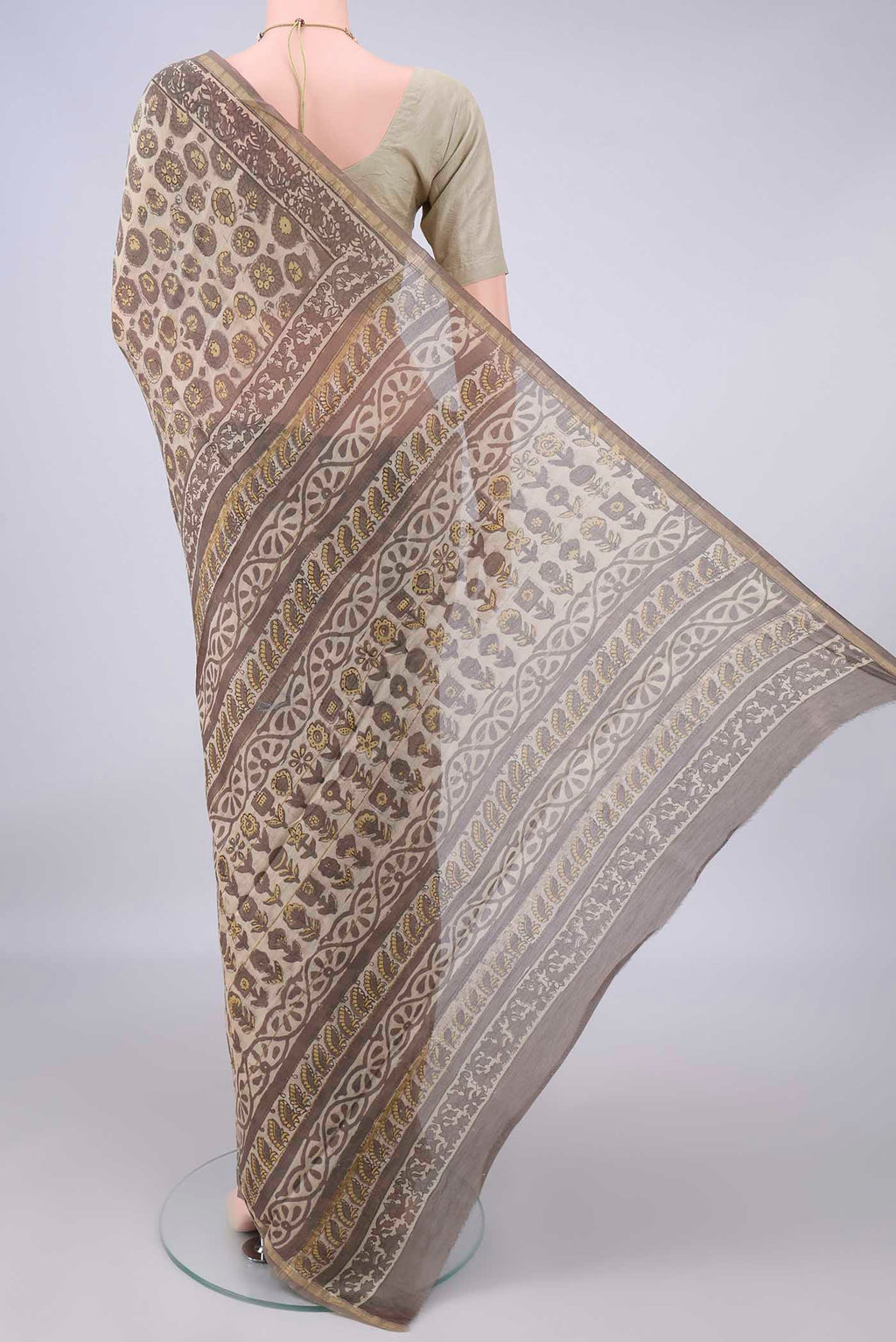Flat view of Beige Chanderi Cotton Saree with Batik Print on the body and Thin Zari Line. 
