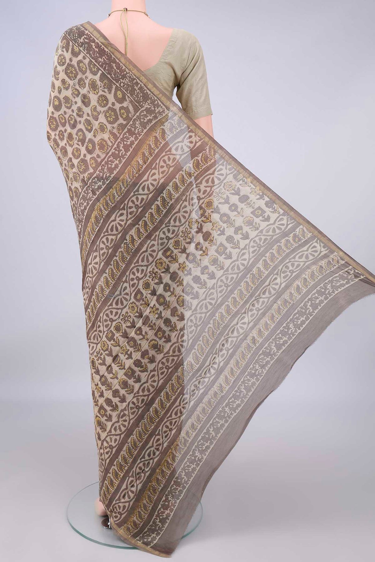 Flat view of Beige Chanderi Cotton Saree with Batik Print on the body and Thin Zari Line. 