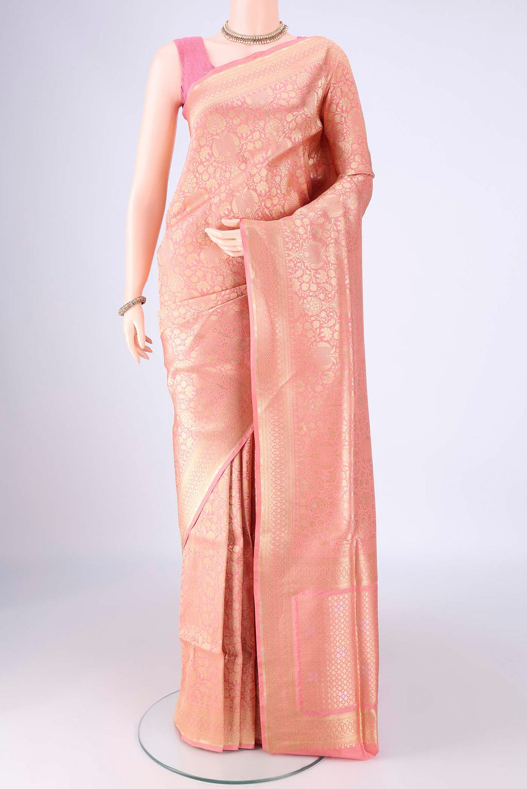 Peach Banarasi Silk Saree with Zari Brocade on the body and Zari Border.  displayed on a mannequin