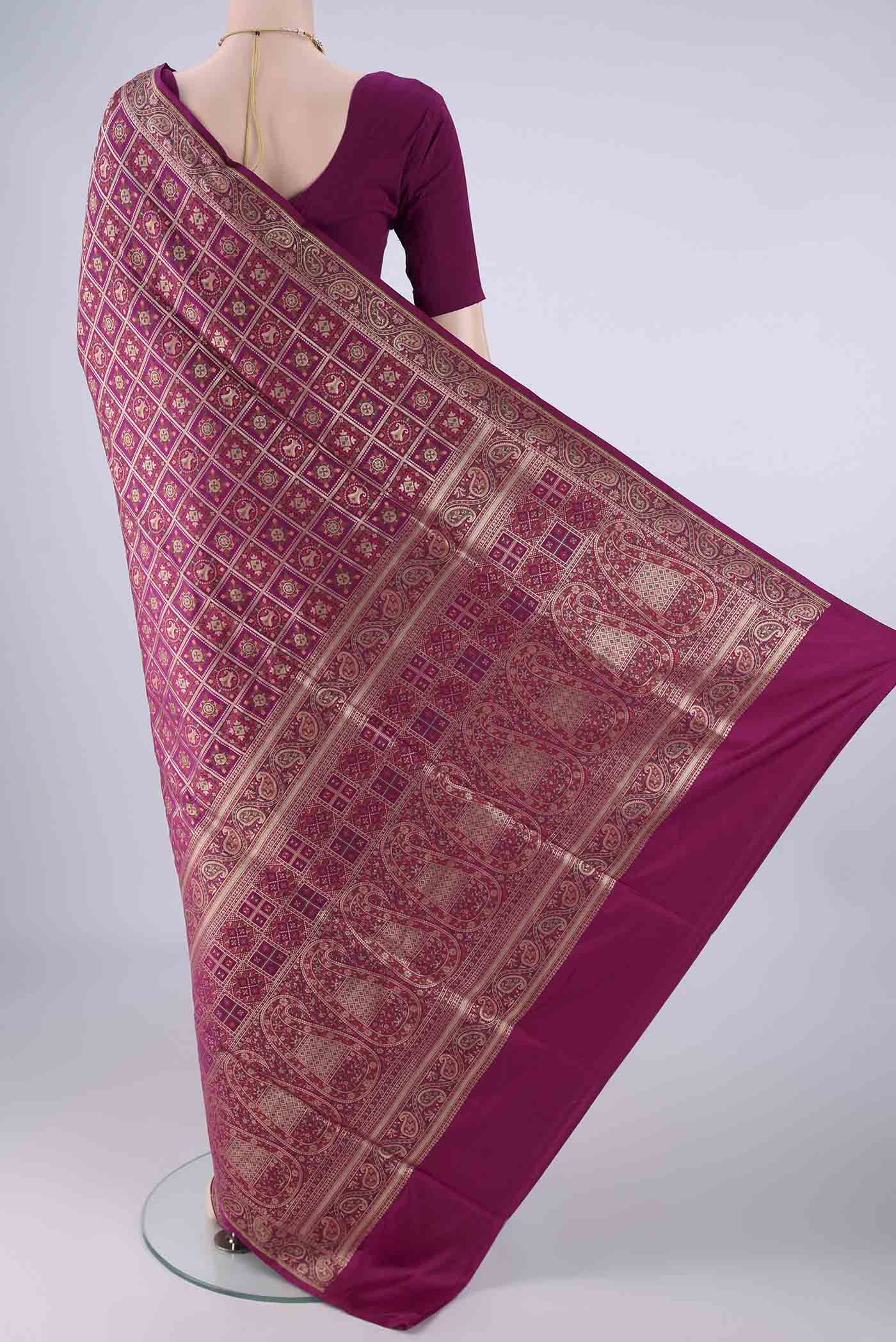 Flat view of Magenta Banarasi Jamavar Saree with Checked design on the body and Zari Border. 