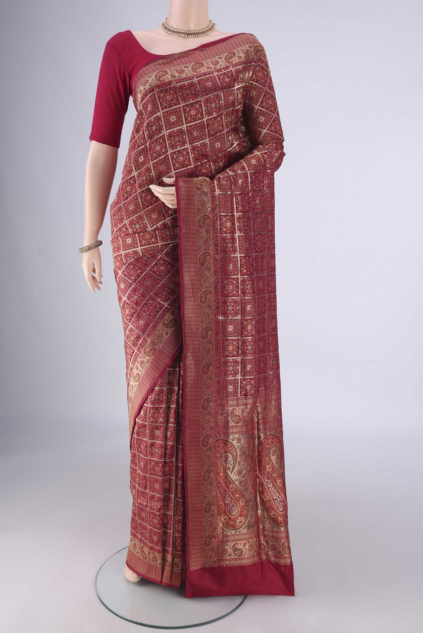 Maroon Banarasi Jamavar Saree with Checked design on the body and Zari Border.  displayed on a mannequin