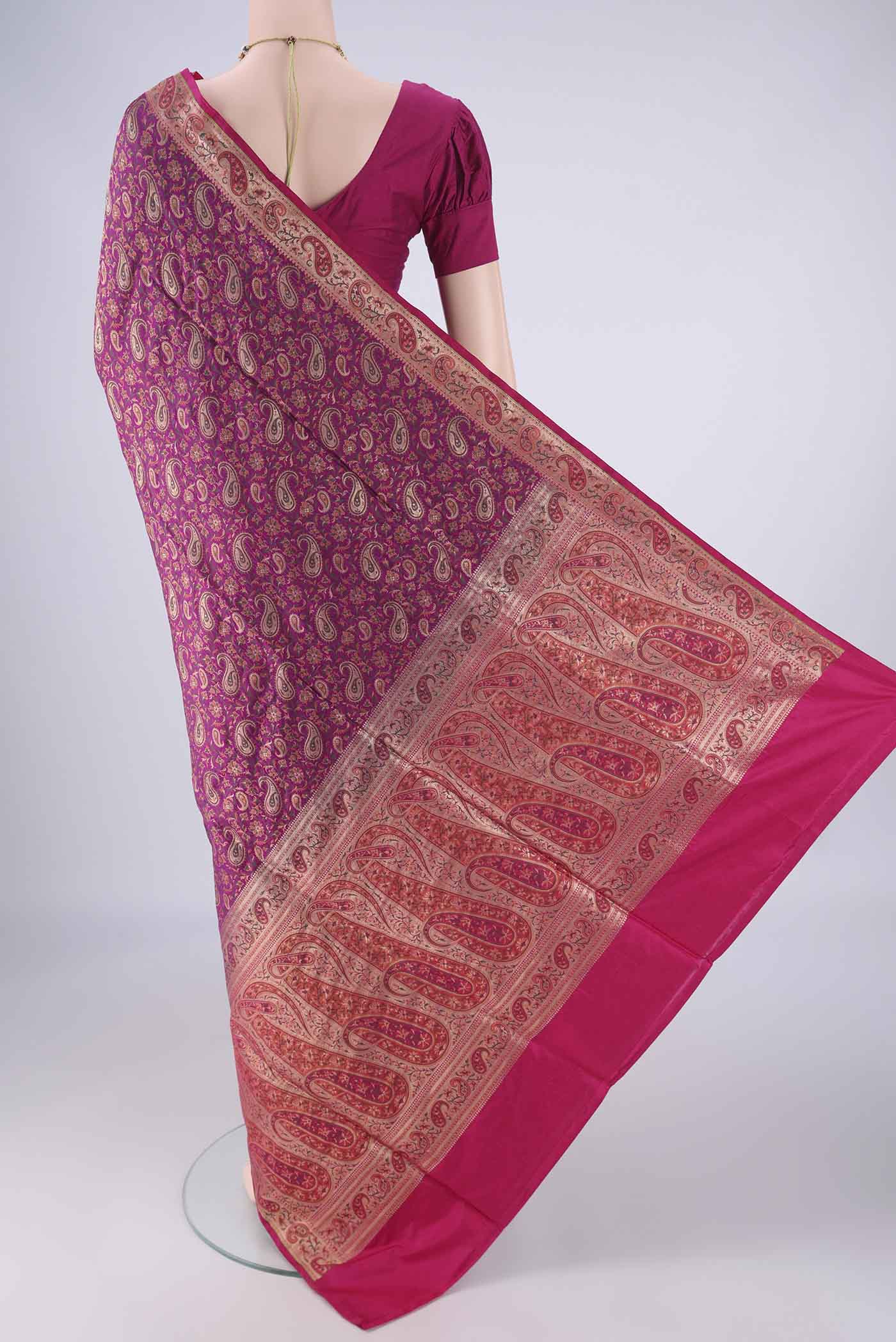 Flat view of Magenta Banarasi Jamavar Saree with Jacquard design on the body and Zari Border. 