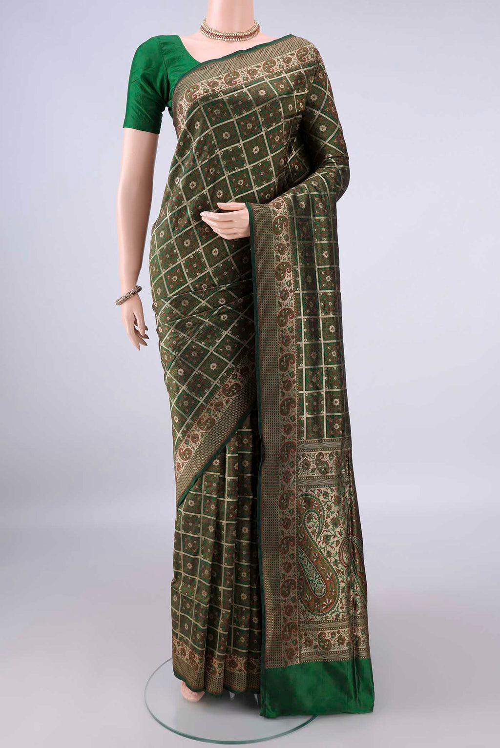 Pure Silk Green Banarasi Jamavar Saree with Checked design on the body and Zari Border.  displayed on a mannequin