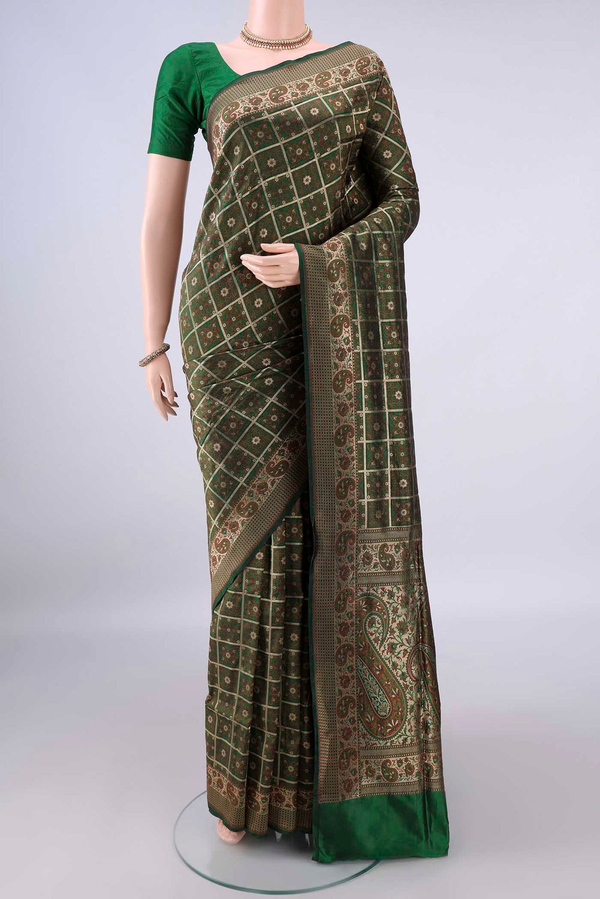 Pure Silk Green Banarasi Jamavar Saree with Checked design on the body and Zari Border.  displayed on a mannequin