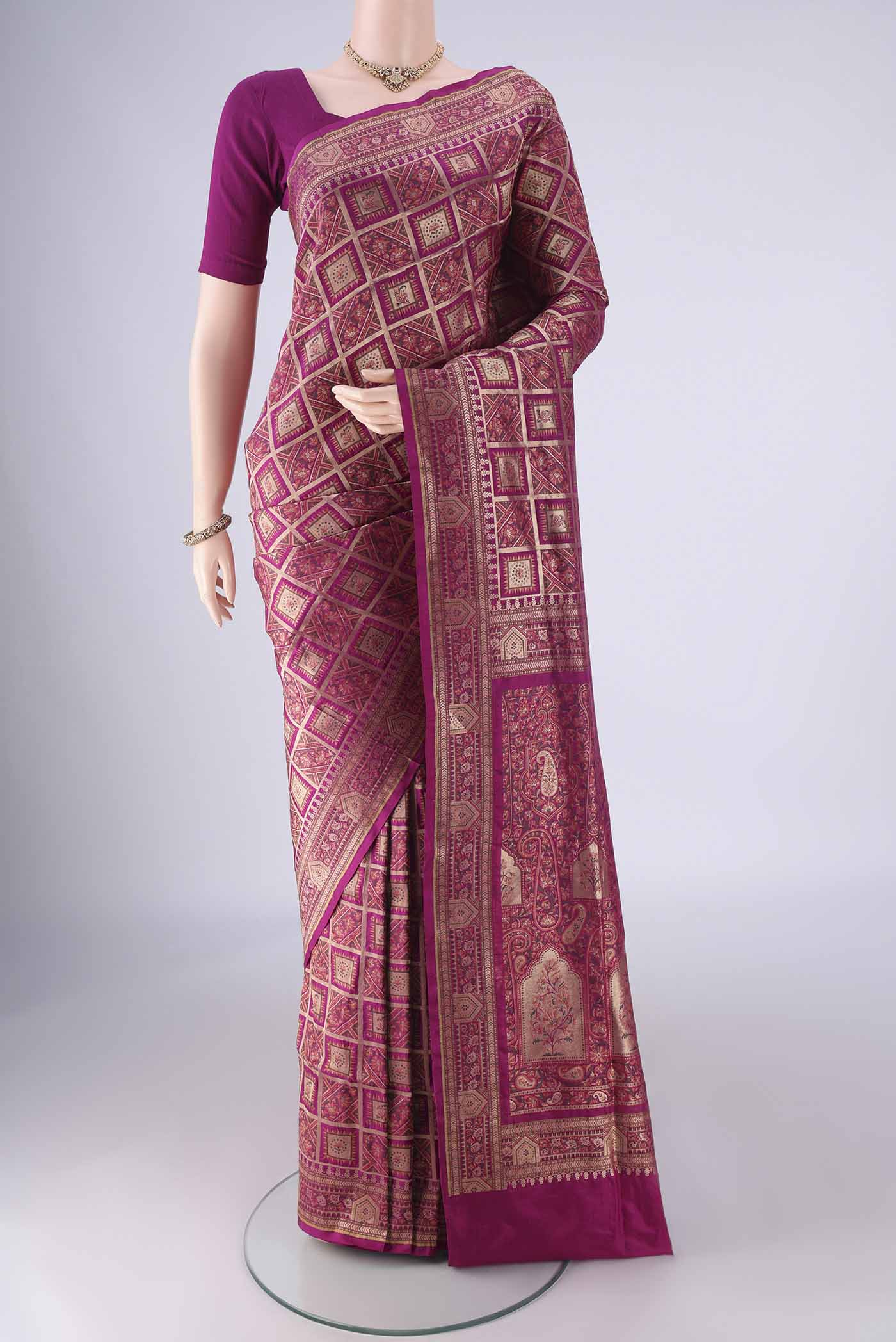 Magenta Banarasi Jamavar Saree with Checked design on the body and Zari Border.  displayed on a mannequin