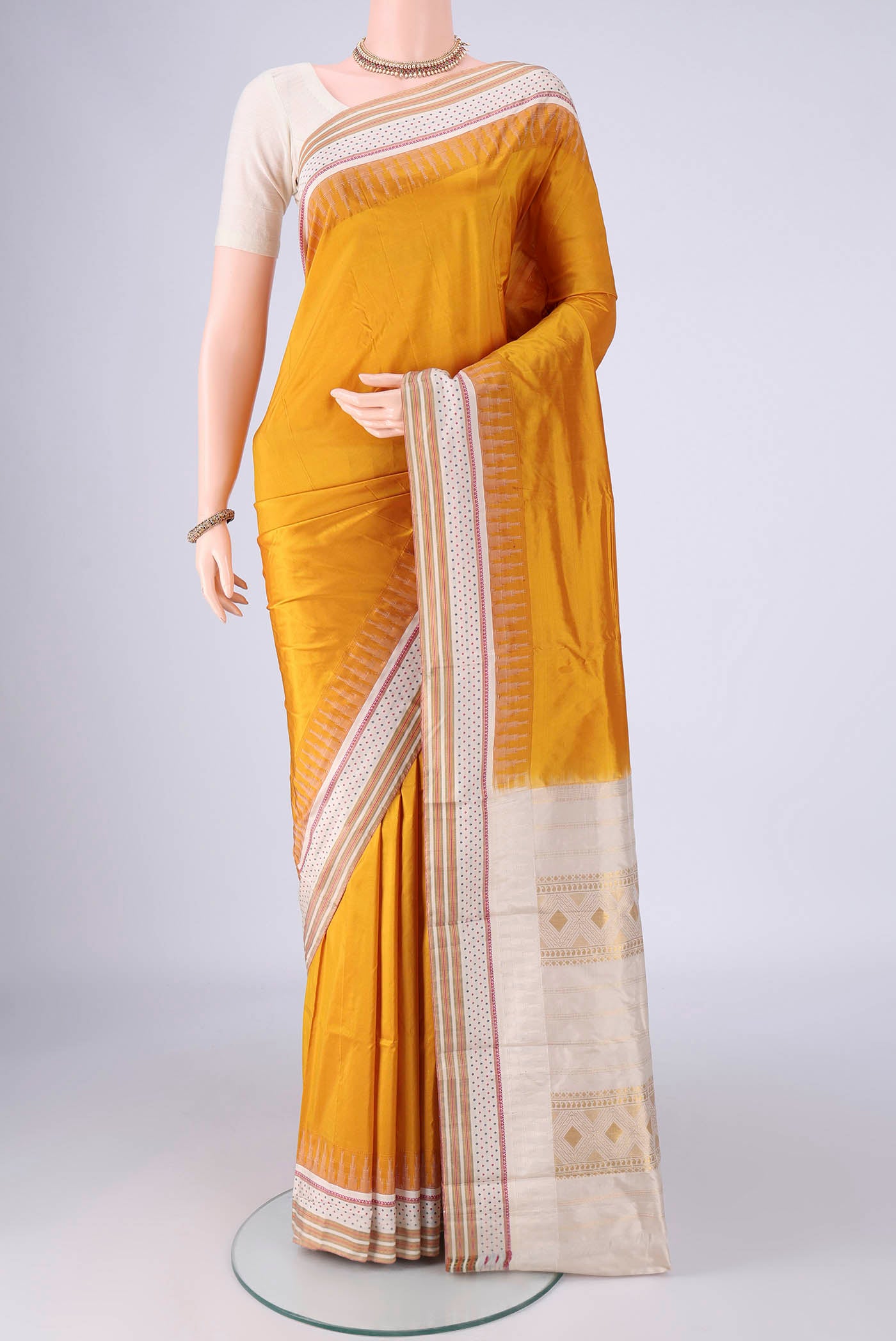 Mustard Bangalore Silk - kadyal Saree with Plain Body and Temple Border.  displayed on a mannequin