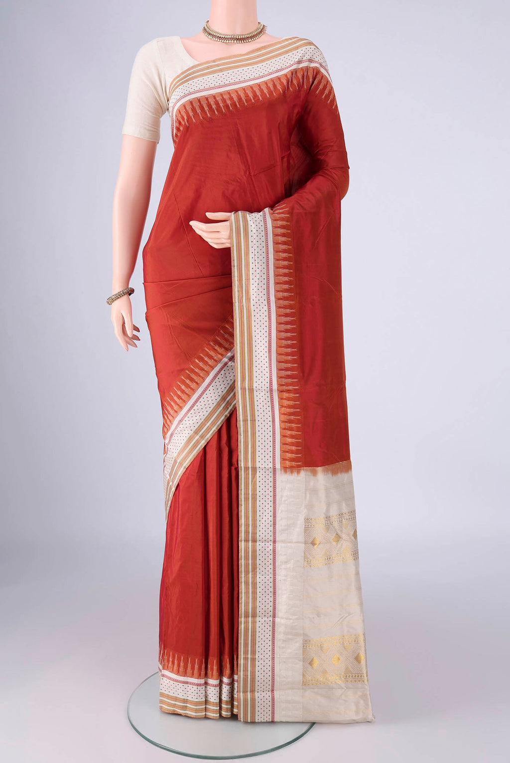 Rust Bangalore Silk - kadyal Saree with Plain Body and Temple Border.  displayed on a mannequin
