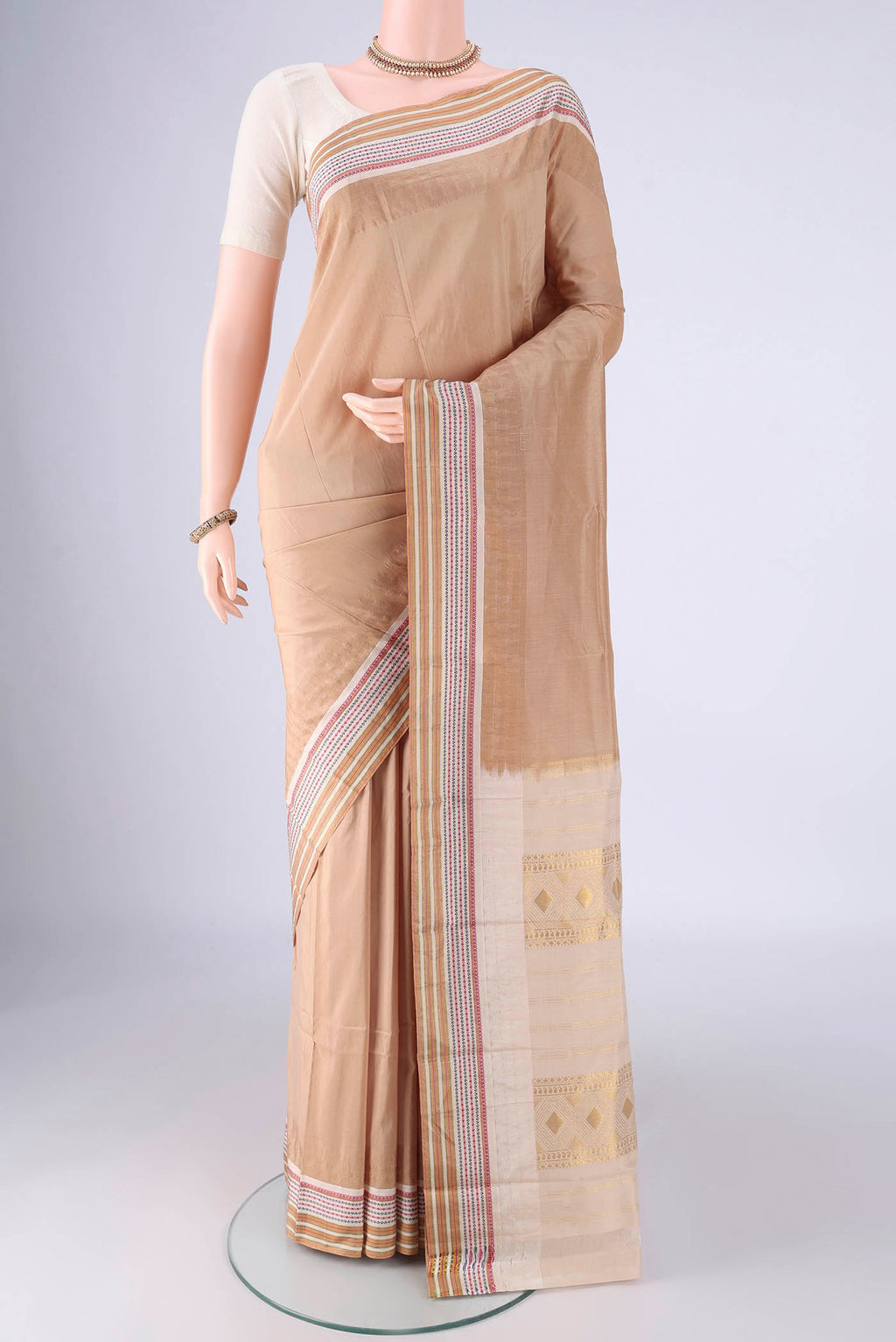 Beige Bangalore Silk - kadyal Saree with Plain Body and Temple Border.  displayed on a mannequin