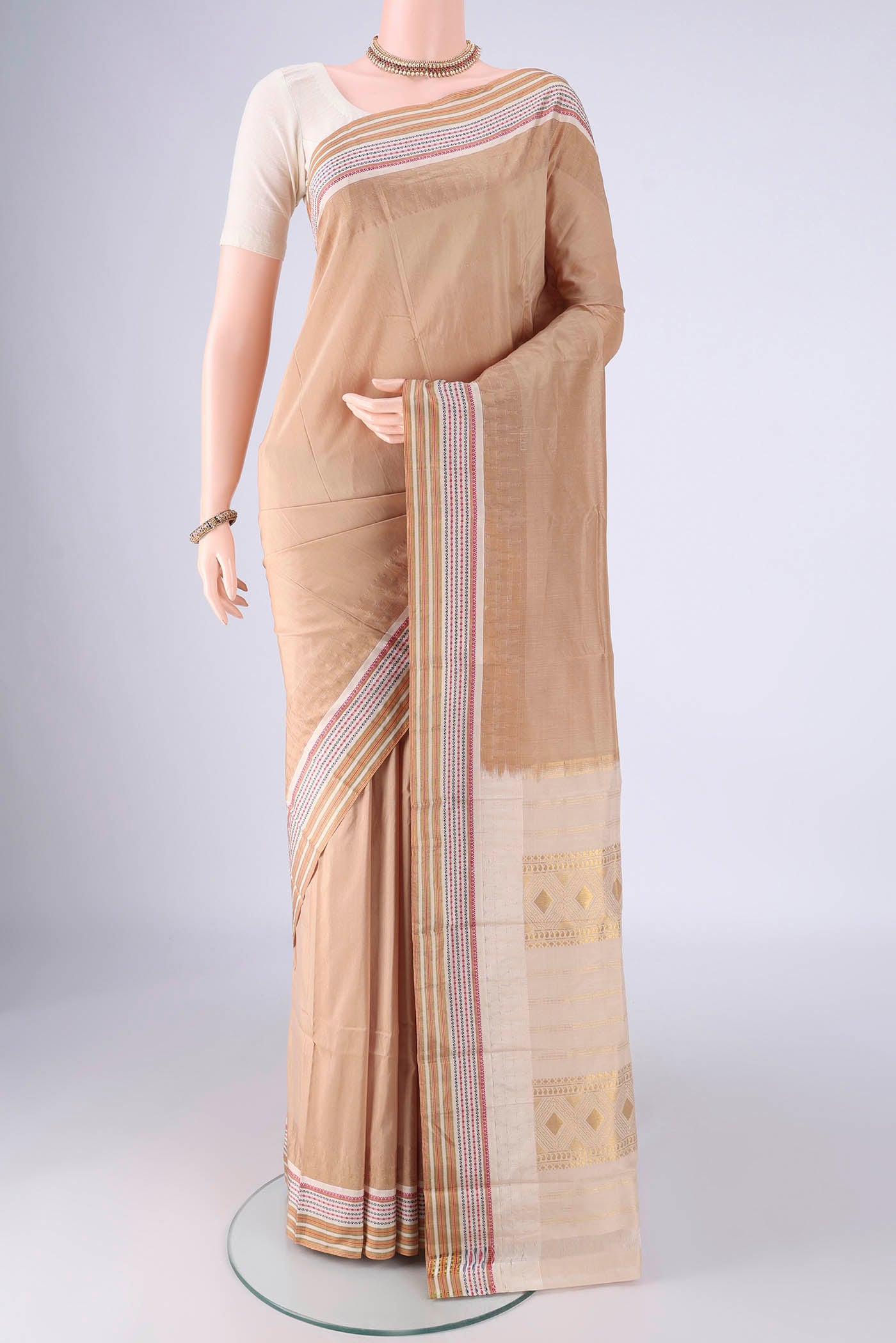 Beige Bangalore Silk - kadyal Saree with Plain Body and Temple Border.  displayed on a mannequin