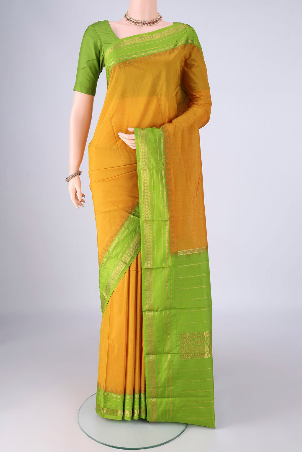Mustard Bangalore Silk - kadyal Saree with Plain Body and Temple Border.  displayed on a mannequin