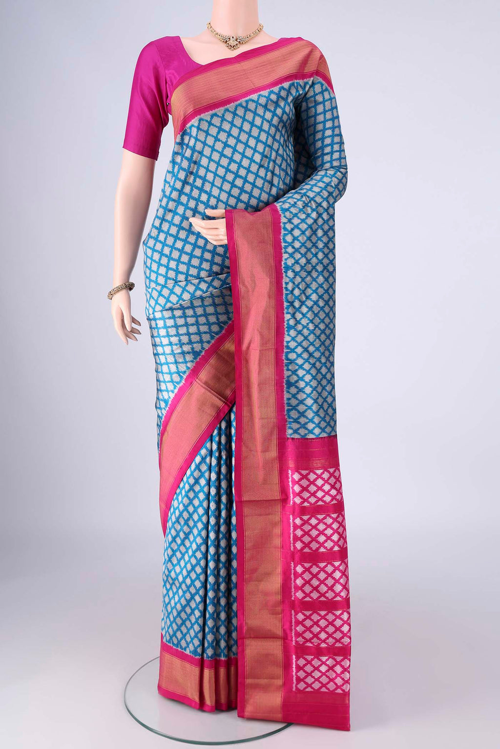 Blue Pochampally Silk Saree with Ikat design on the body and Zari Border.  displayed on a mannequin