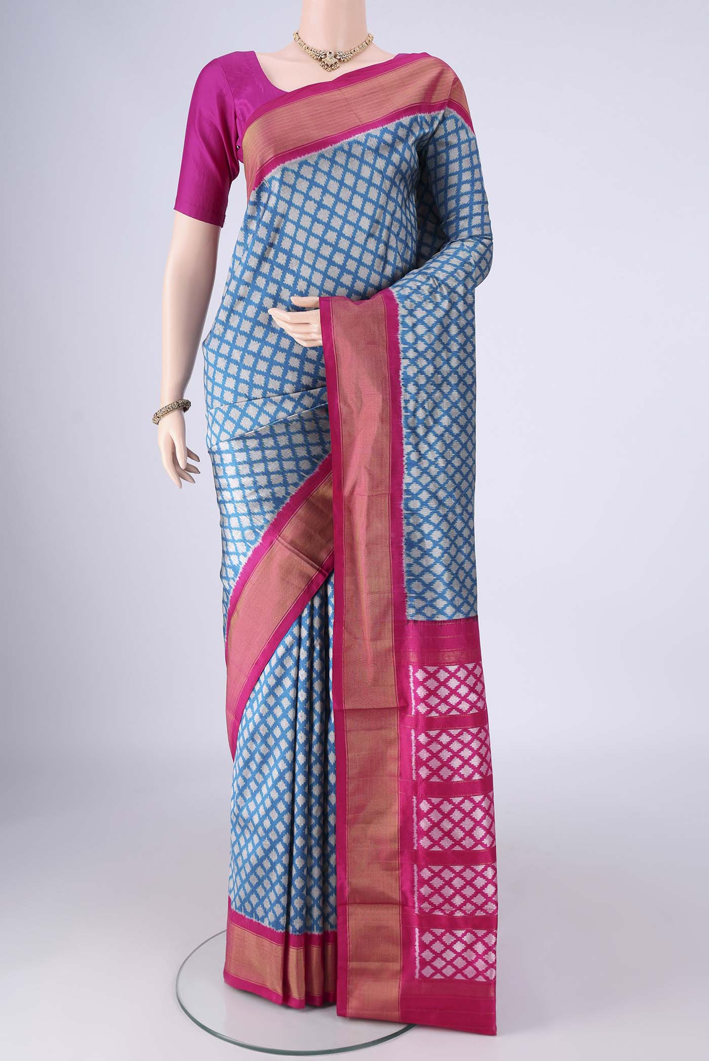 Blue Pochampally Silk Saree with Ikat design on the body and Zari Border.  displayed on a mannequin