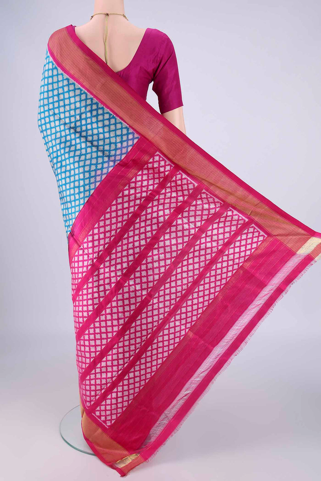 Flat view of Blue Pochampally Silk Saree with Ikat design on the body and Zari Border. 