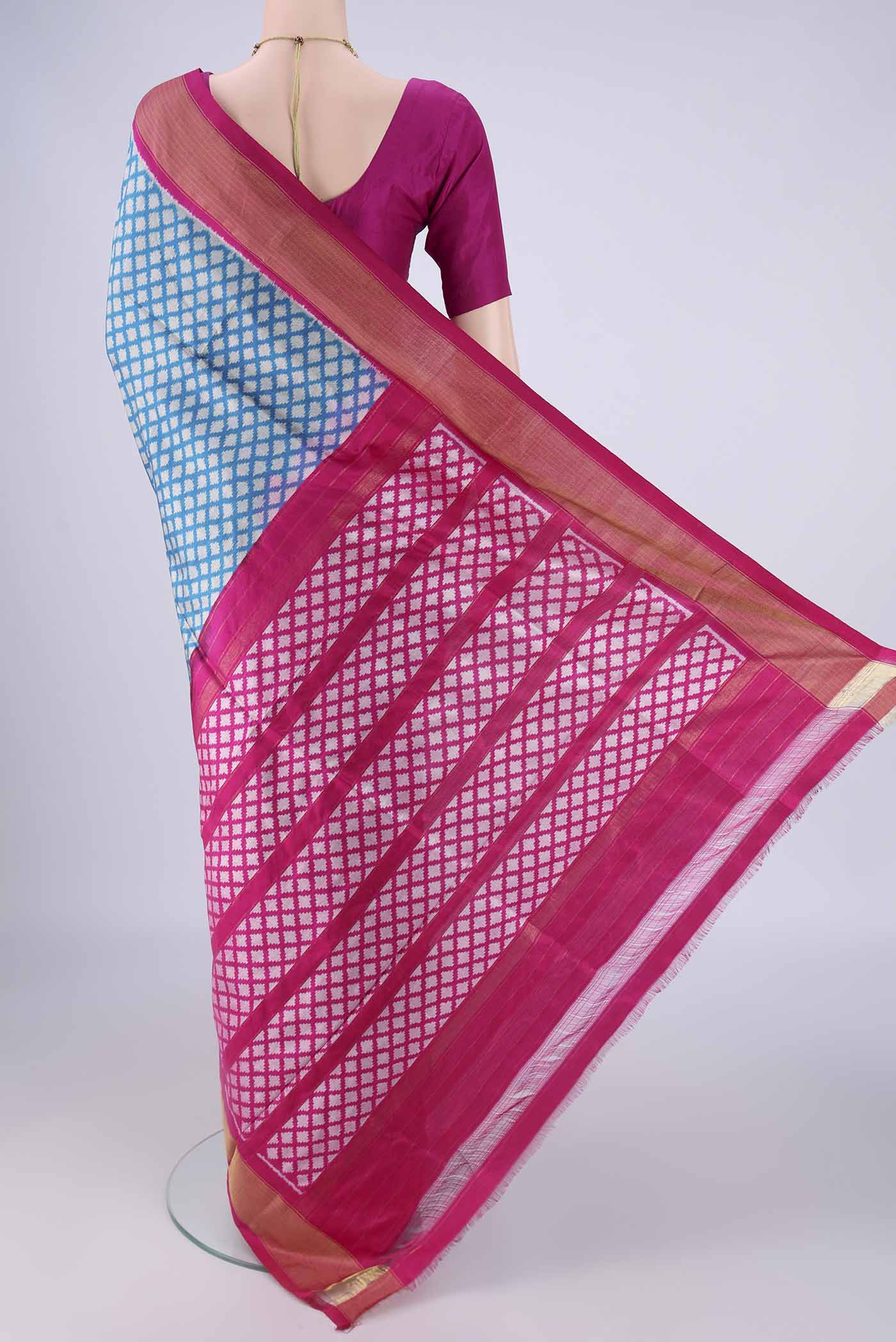 Flat view of Blue Pochampally Silk Saree with Ikat design on the body and Zari Border. 