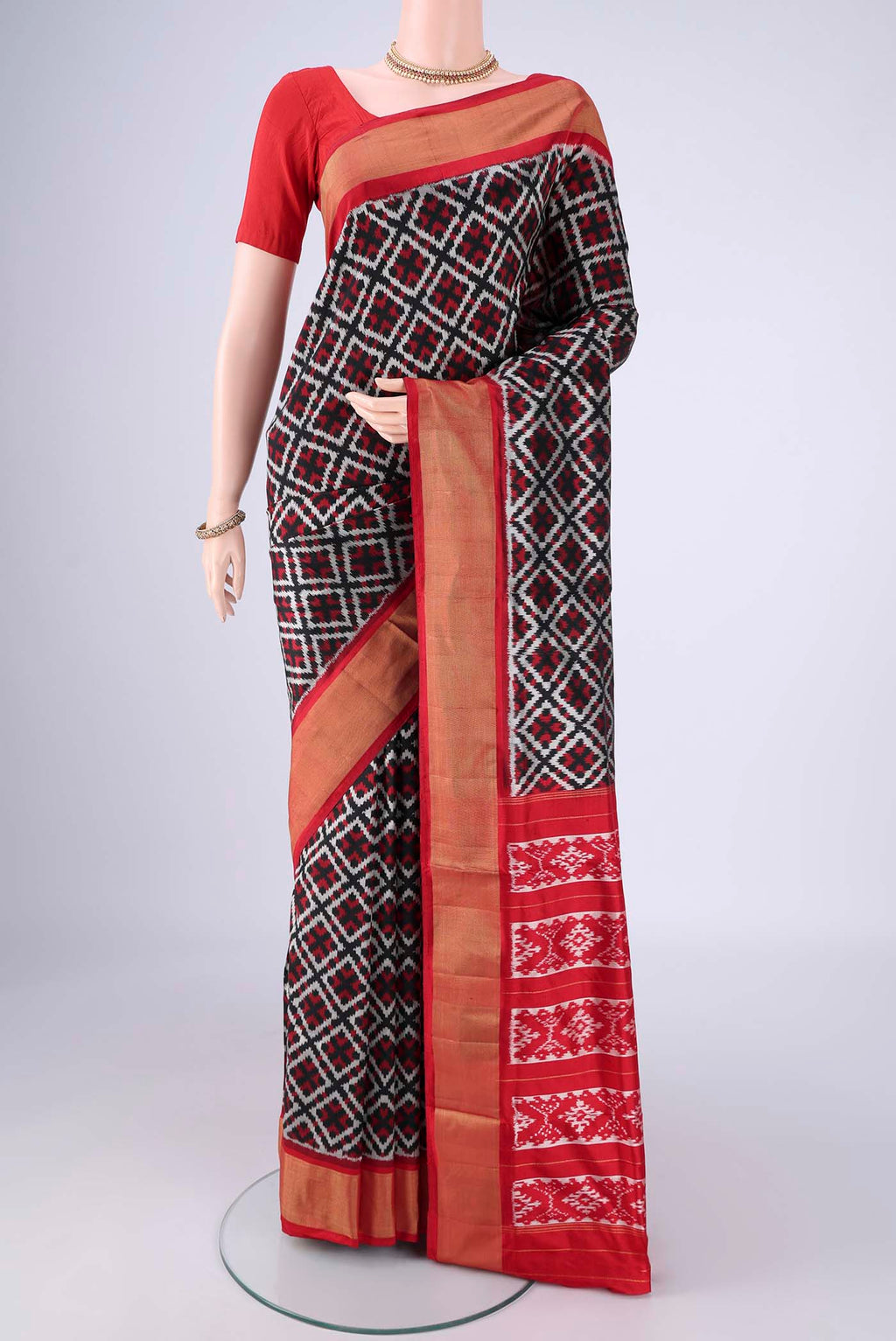 Black Pochampally Silk Saree with Pure Ikat on the body and Zari Border.  displayed on a mannequin