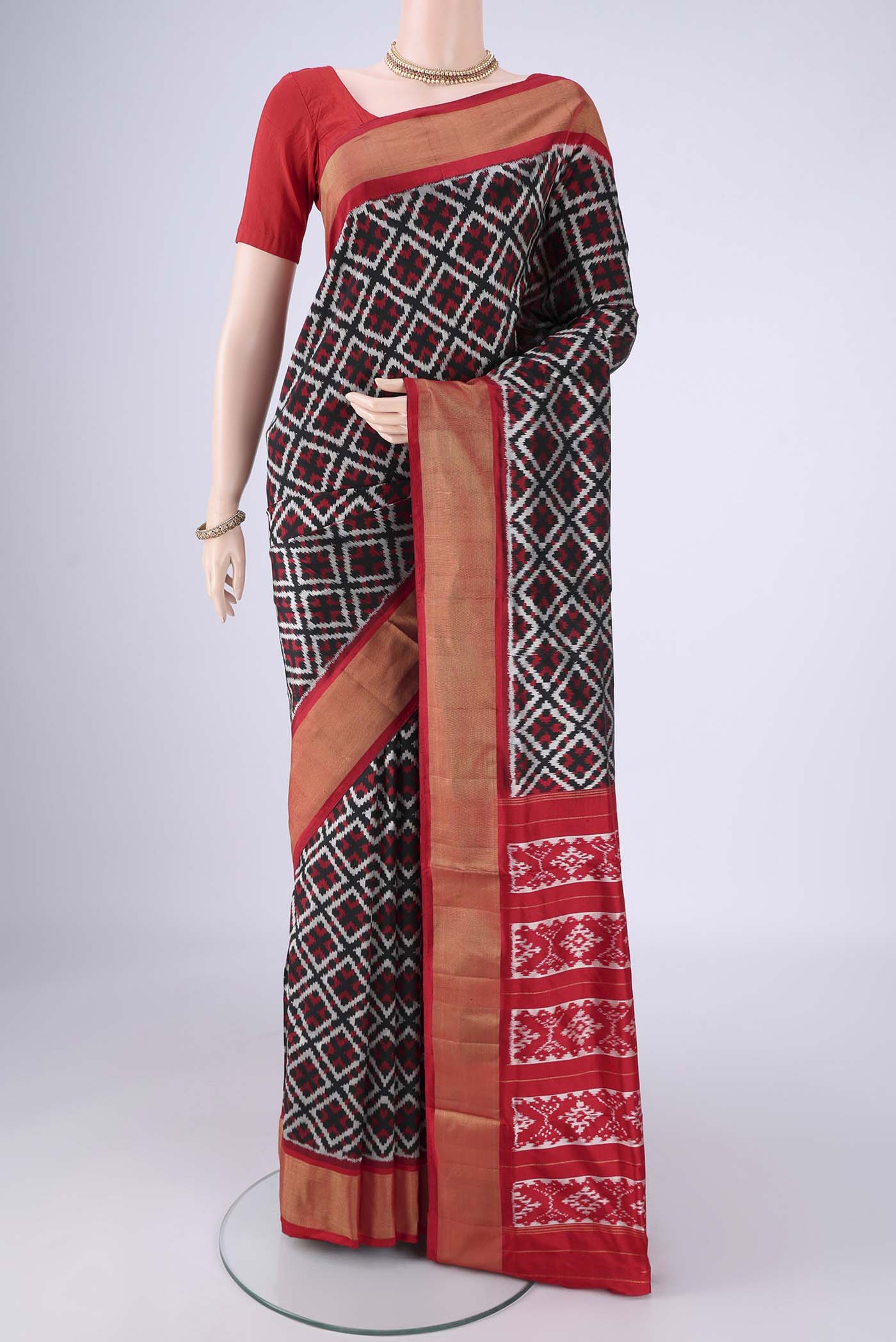 Black Pochampally Silk Saree with Pure Ikat on the body and Zari Border.  displayed on a mannequin