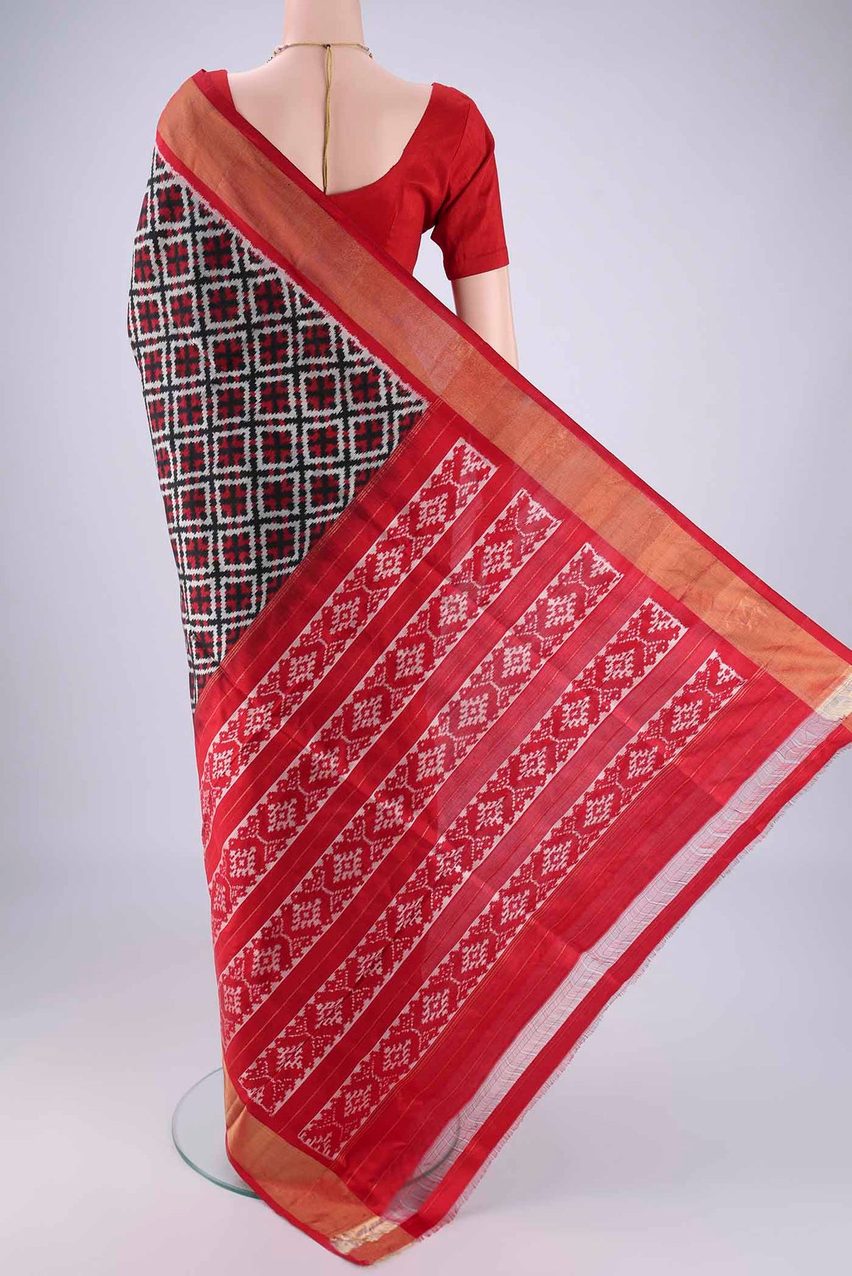 Flat view of Black Pochampally Silk Saree with Pure Ikat on the body and Zari Border. 