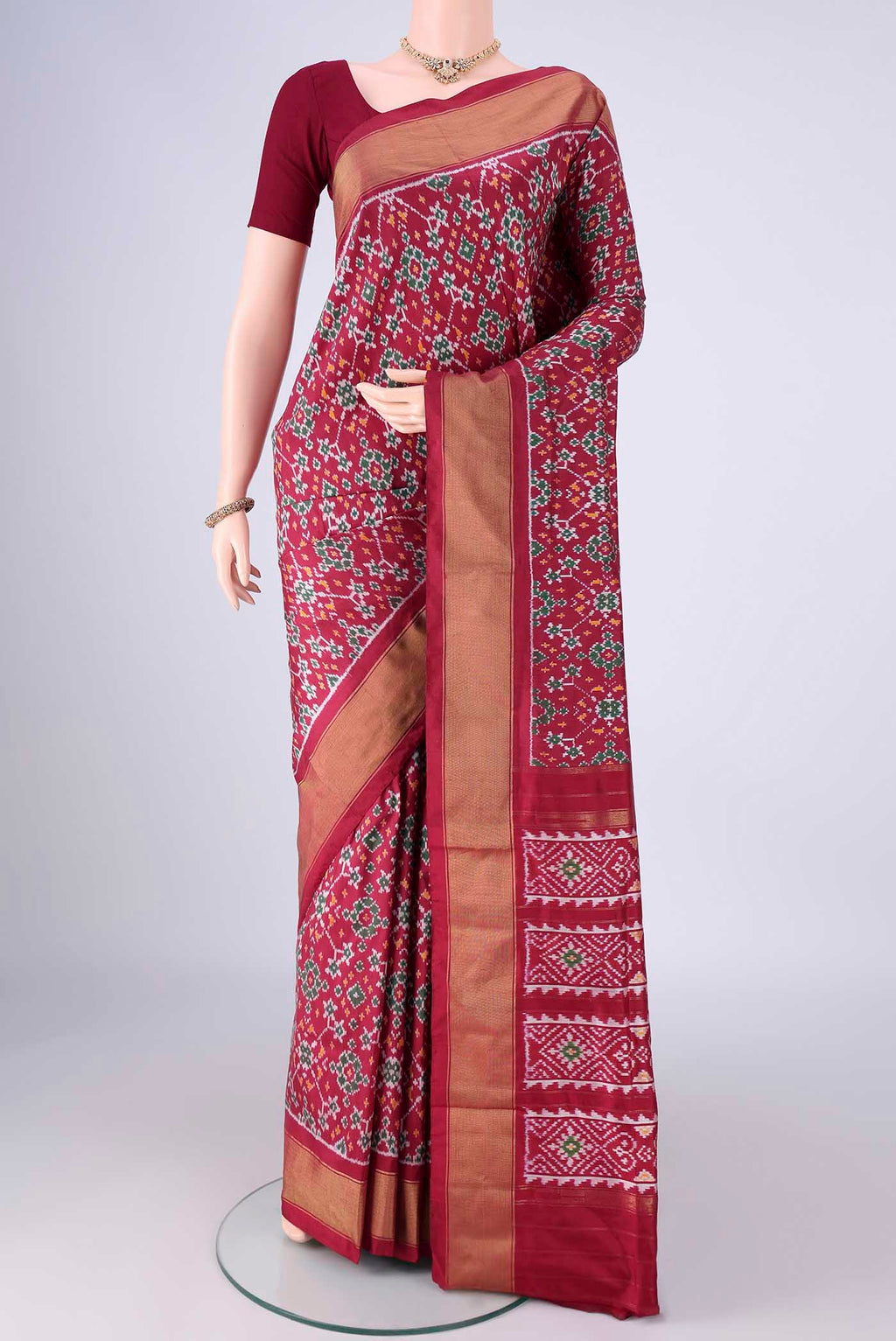 Maroon Pochampally Silk Saree with Ikat design on the body and Zari Border.  displayed on a mannequin