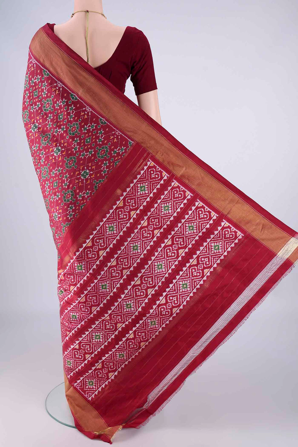 Flat view of Maroon Pochampally Silk Saree with Ikat design on the body and Zari Border. 