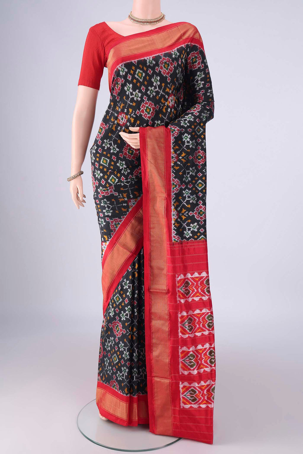 Black Pochampally Silk Saree with Pure Ikat on the body and Zari Border.  displayed on a mannequin