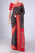 Black Pochampally Silk Saree with Pure Ikat on the body and Zari Border.  displayed on a mannequin