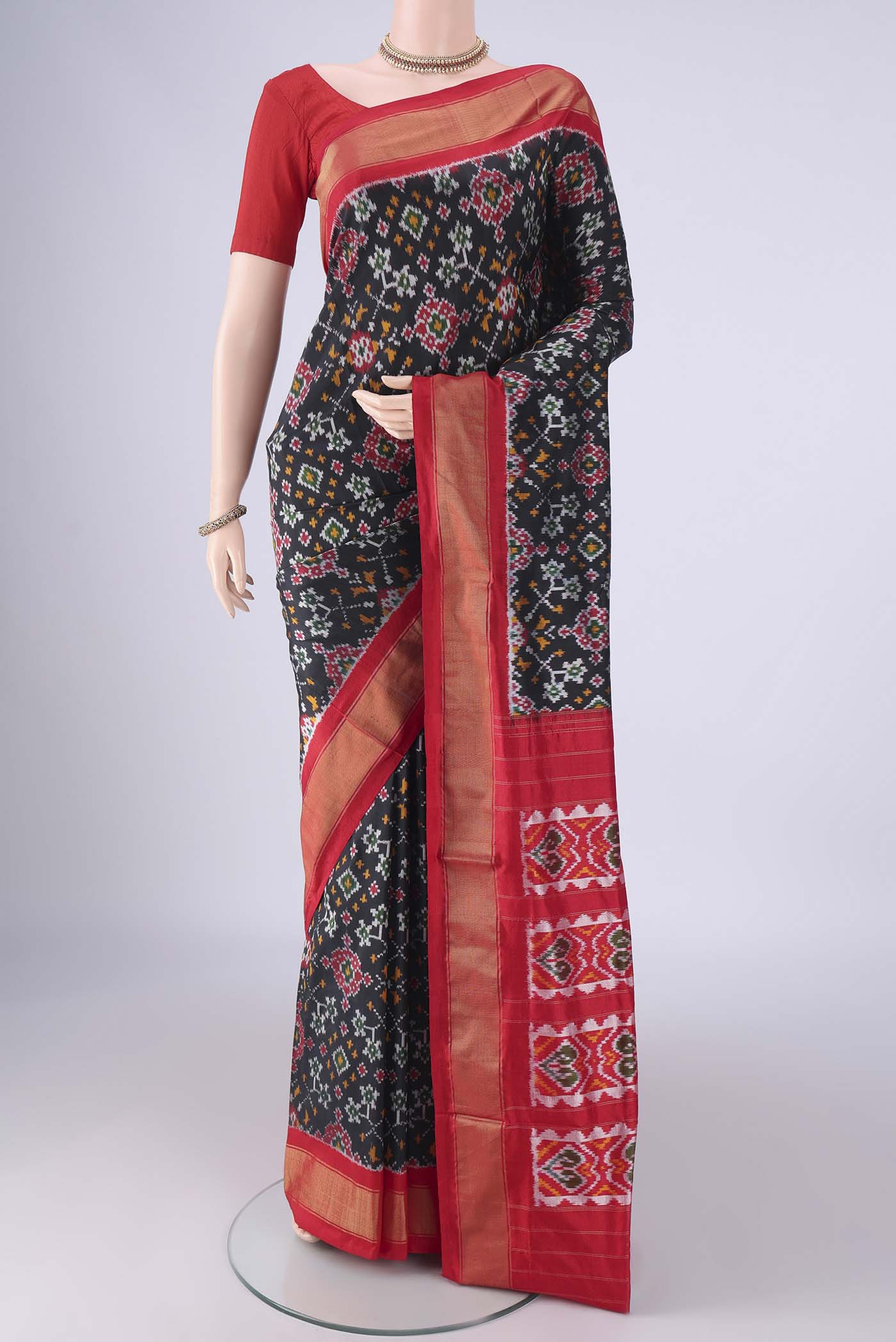 Black Pochampally Silk Saree with Pure Ikat on the body and Zari Border.  displayed on a mannequin
