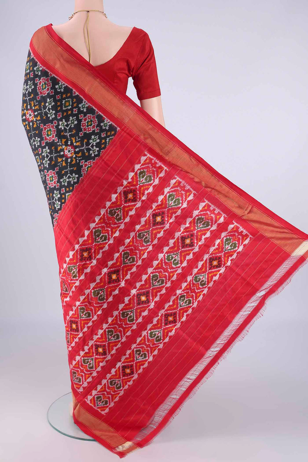 Flat view of Black Pochampally Silk Saree with Pure Ikat on the body and Zari Border. 