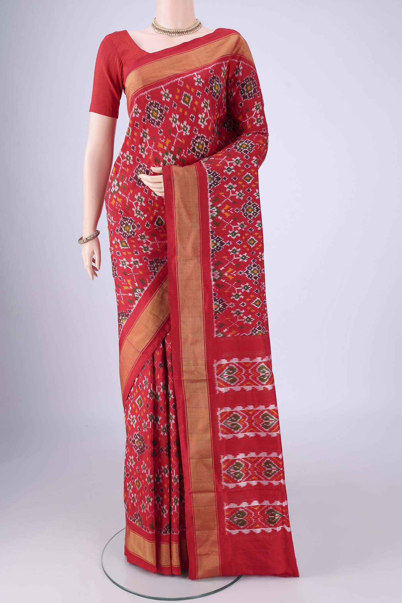 Red Pochampally Silk Saree with Pure Ikat on the body and Zari Border.  displayed on a mannequin