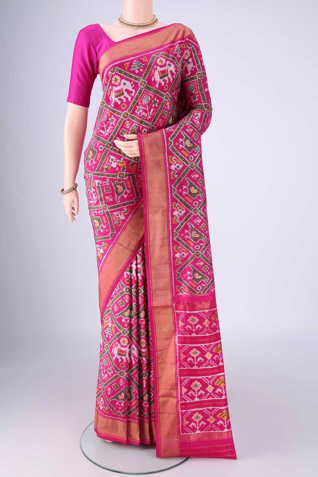 Rani Pink Pochampally Silk Saree with Pure Ikat on the body and Zari Border.  displayed on a mannequin