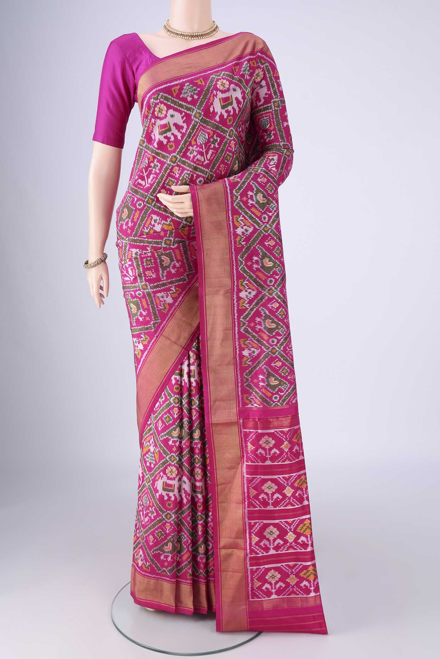 Rani Pink Pochampally Silk Saree with Pure Ikat on the body and Zari Border.  displayed on a mannequin