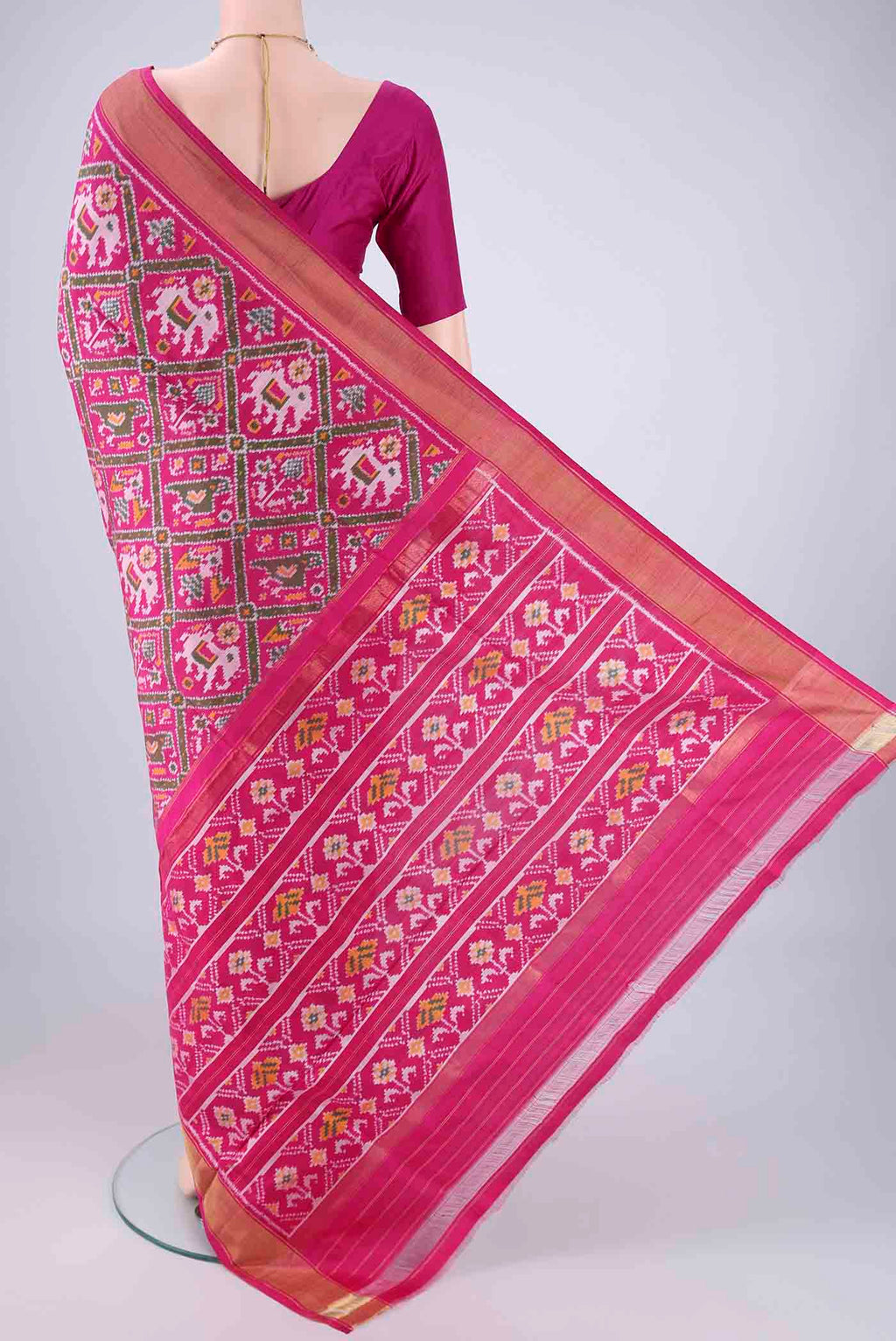 Flat view of Rani Pink Pochampally Silk Saree with Pure Ikat on the body and Zari Border. 