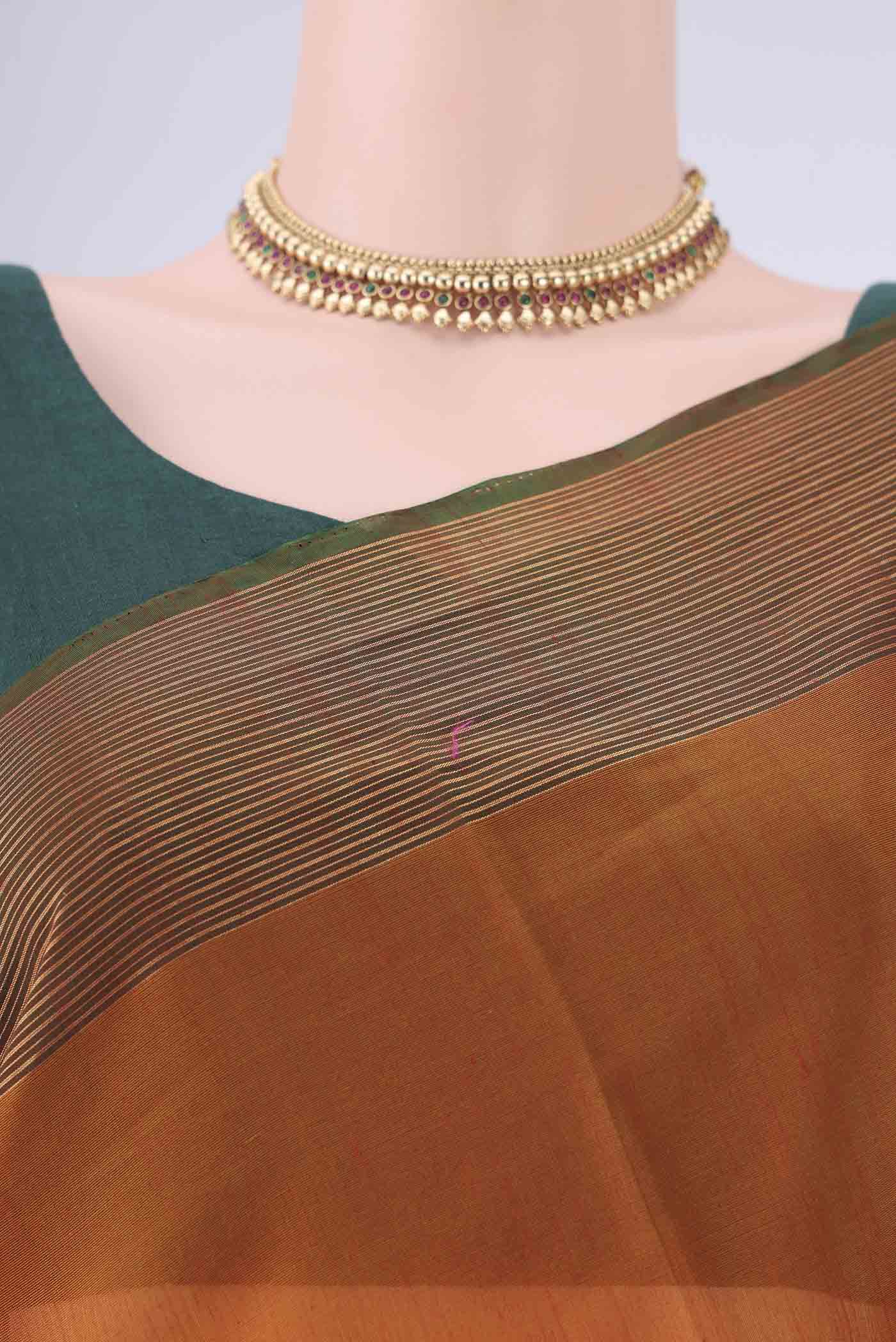 Border image of Rust Kora Cotton Saree with Zari Butta on the body and Zari Border. 