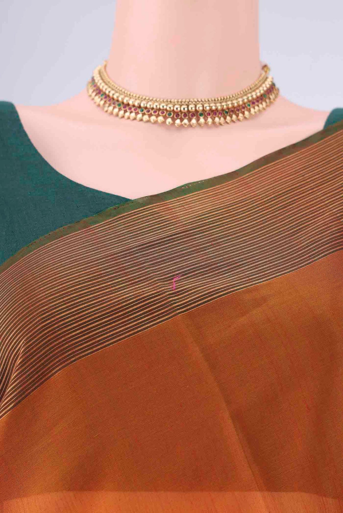 Border image of Rust Kora Cotton Saree with Zari Butta on the body and Zari Border. 