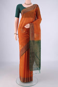 Rust Kora Cotton Saree with Zari Butta on the body and Zari Border.  displayed on a mannequin