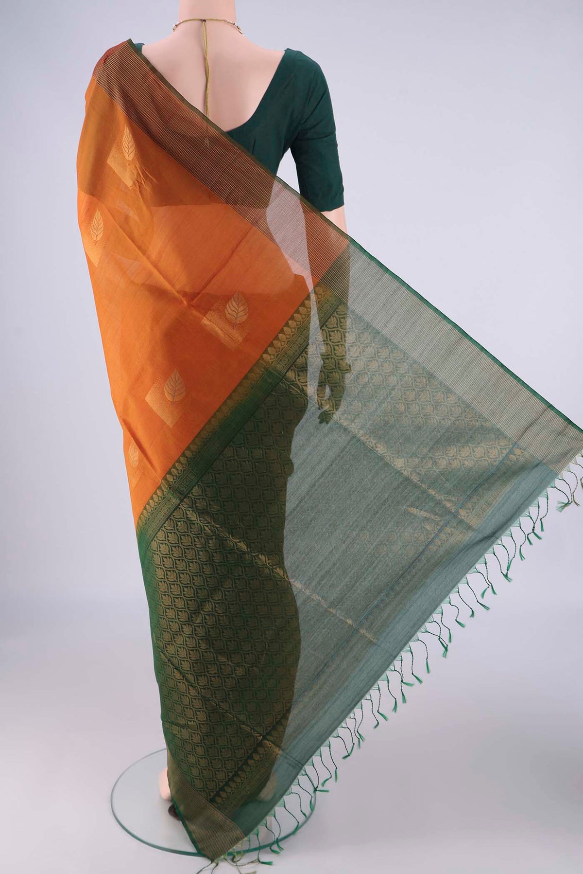 Flat view of Rust Kora Cotton Saree with Zari Butta on the body and Zari Border. 