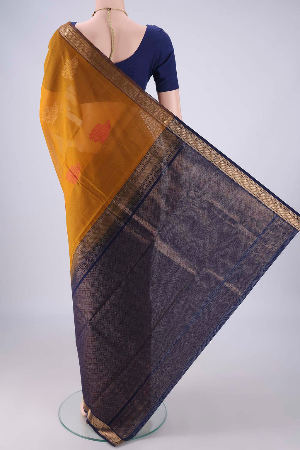 Flat view of Mustard Silk Cotton Saree with Zari Butta on the body and Zari Border. 