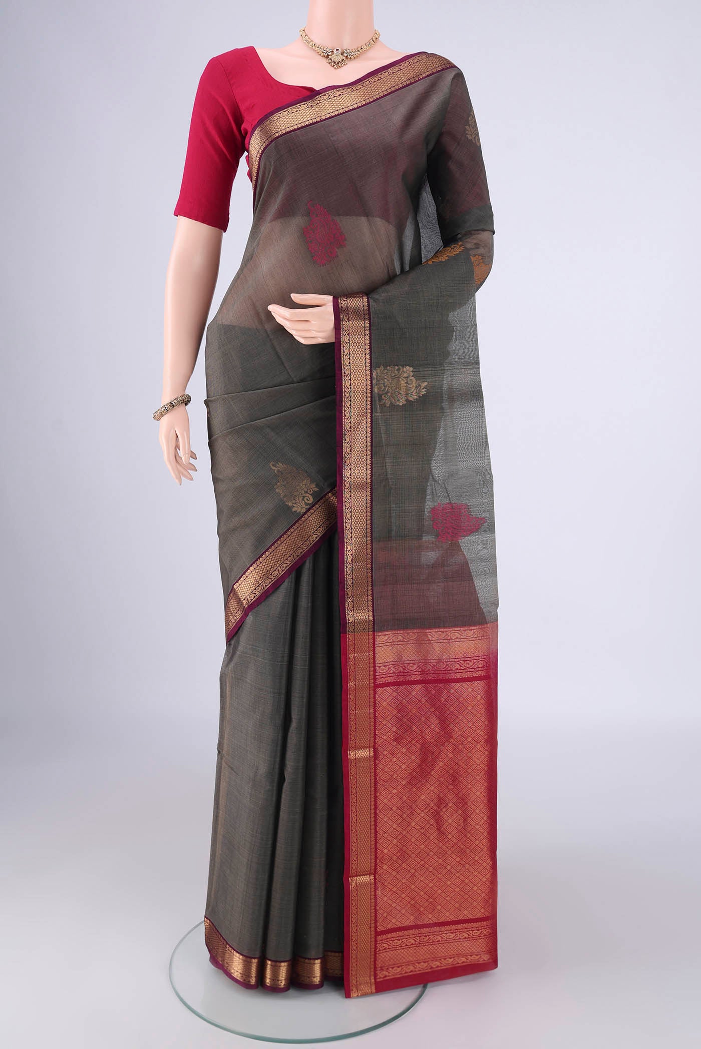 Davys Grey Silk Cotton Saree with Zari Butta on the body and Zari Border.  displayed on a mannequin