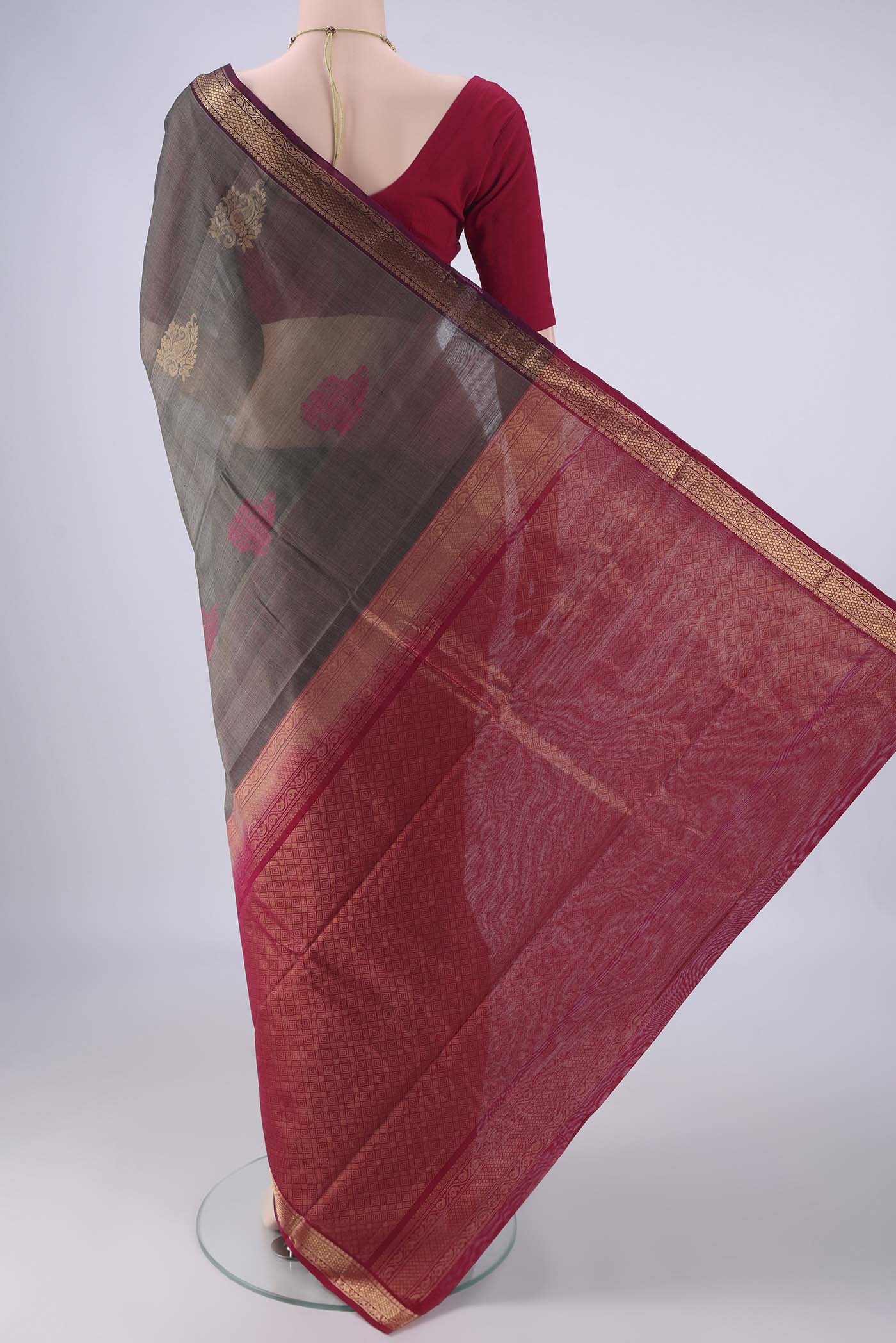 Flat view of Davys Grey Silk Cotton Saree with Zari Butta on the body and Zari Border. 