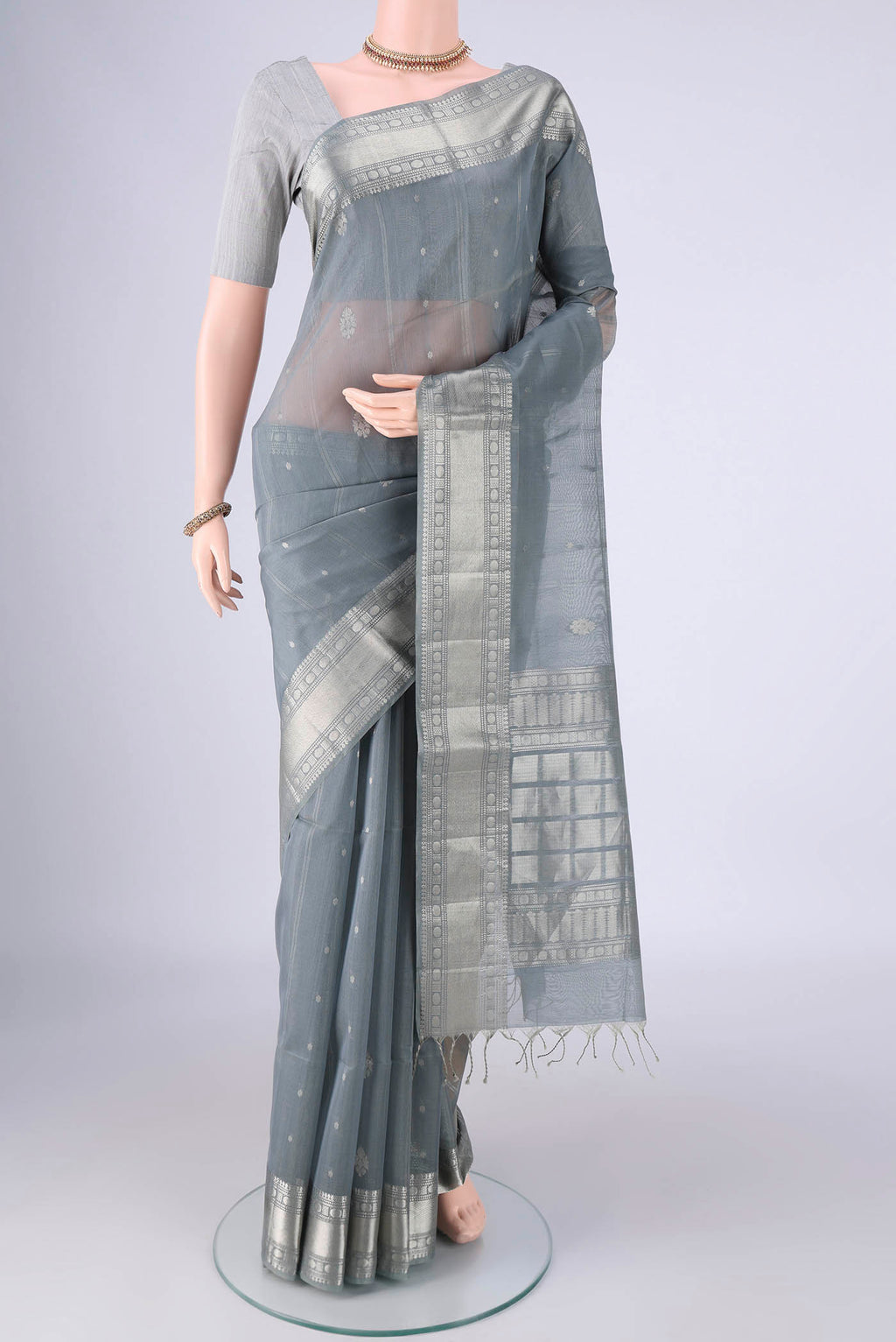 Grey Silk Cotton Saree with Zari Butta on the body and Zari Border.  displayed on a mannequin