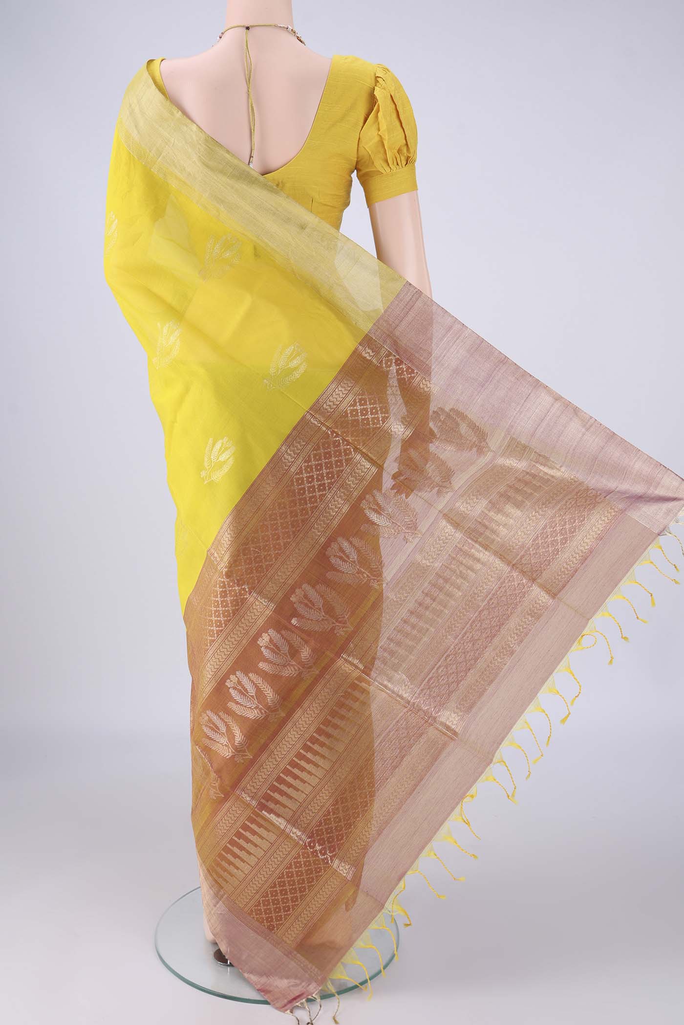Flat view of Yellow Silk Cotton Saree with Zari Butta on the body and Zari Border. 